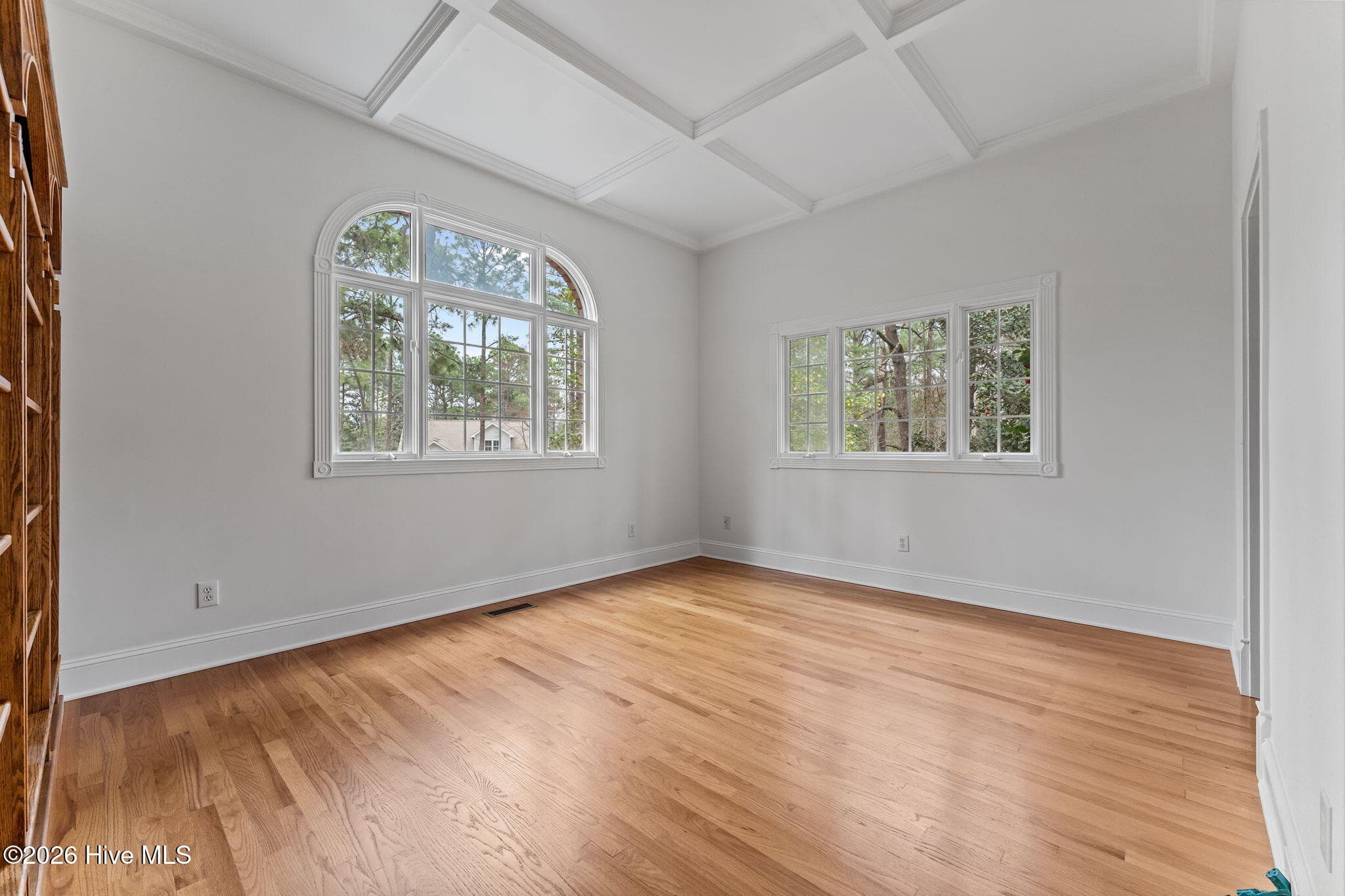 Turning left from the foyer into the Den with built in bookcases. - 22 Lochmere Drive, Pinehurst, NC 28374
