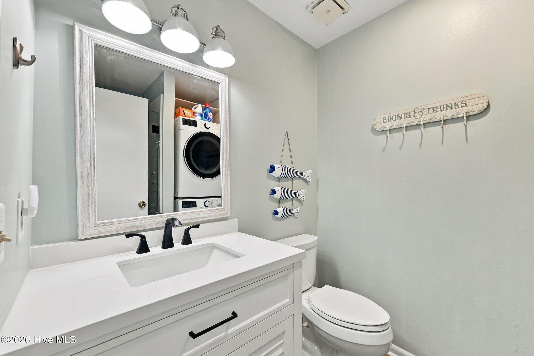 Hall bathroom with walk in shower and laundry - 118 Periwinkle Drive, Emerald Isle, NC 28594