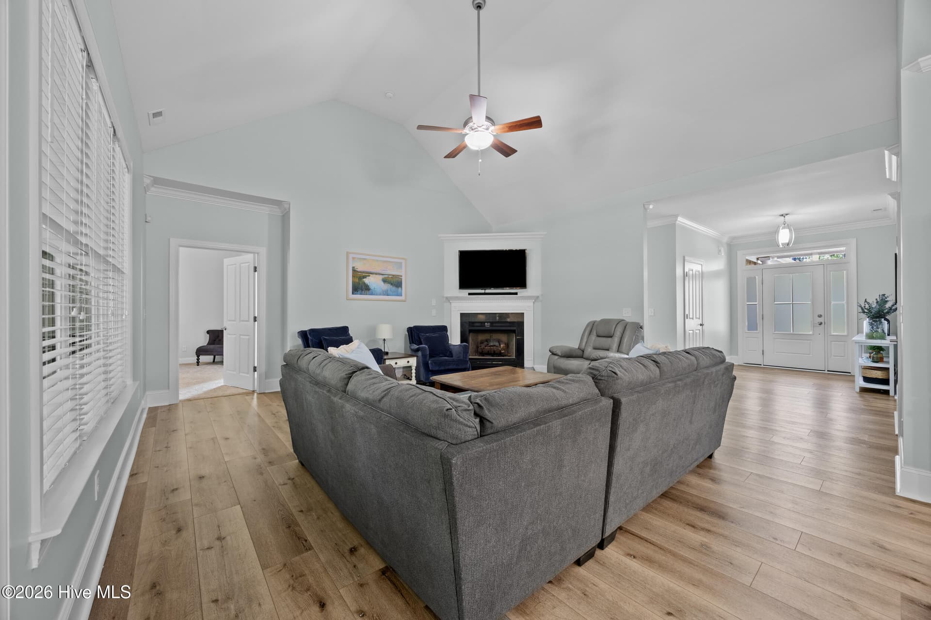 Open living room with fireplace - 323 Crown Pointe Drive, Hampstead, NC 28443
