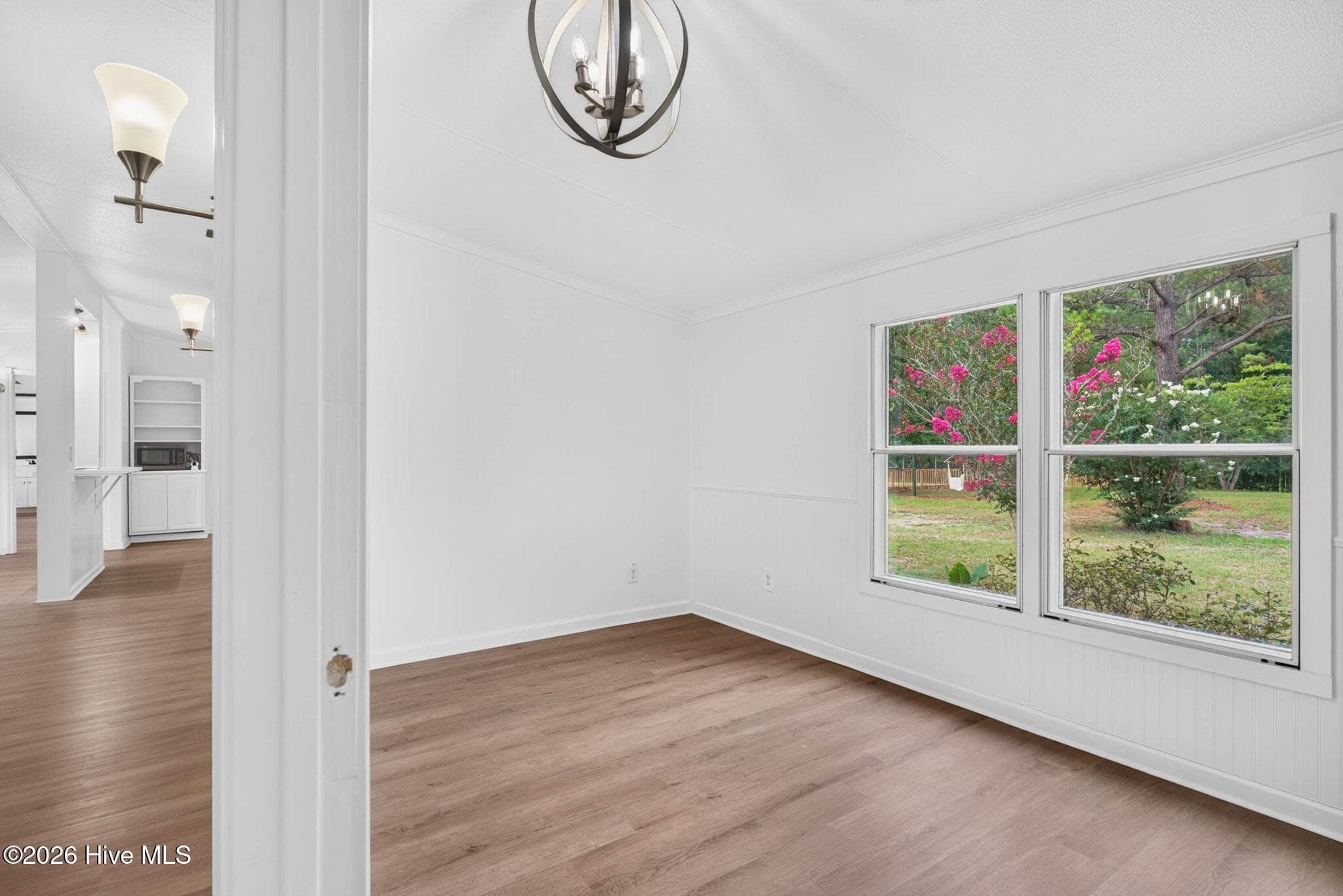 Bright and spacious secondary bedroom featuring large windows, updated flooring, and plenty of room for family, guests, or a home office. - 1199 Zack Street SE, Bolivia, NC 28422