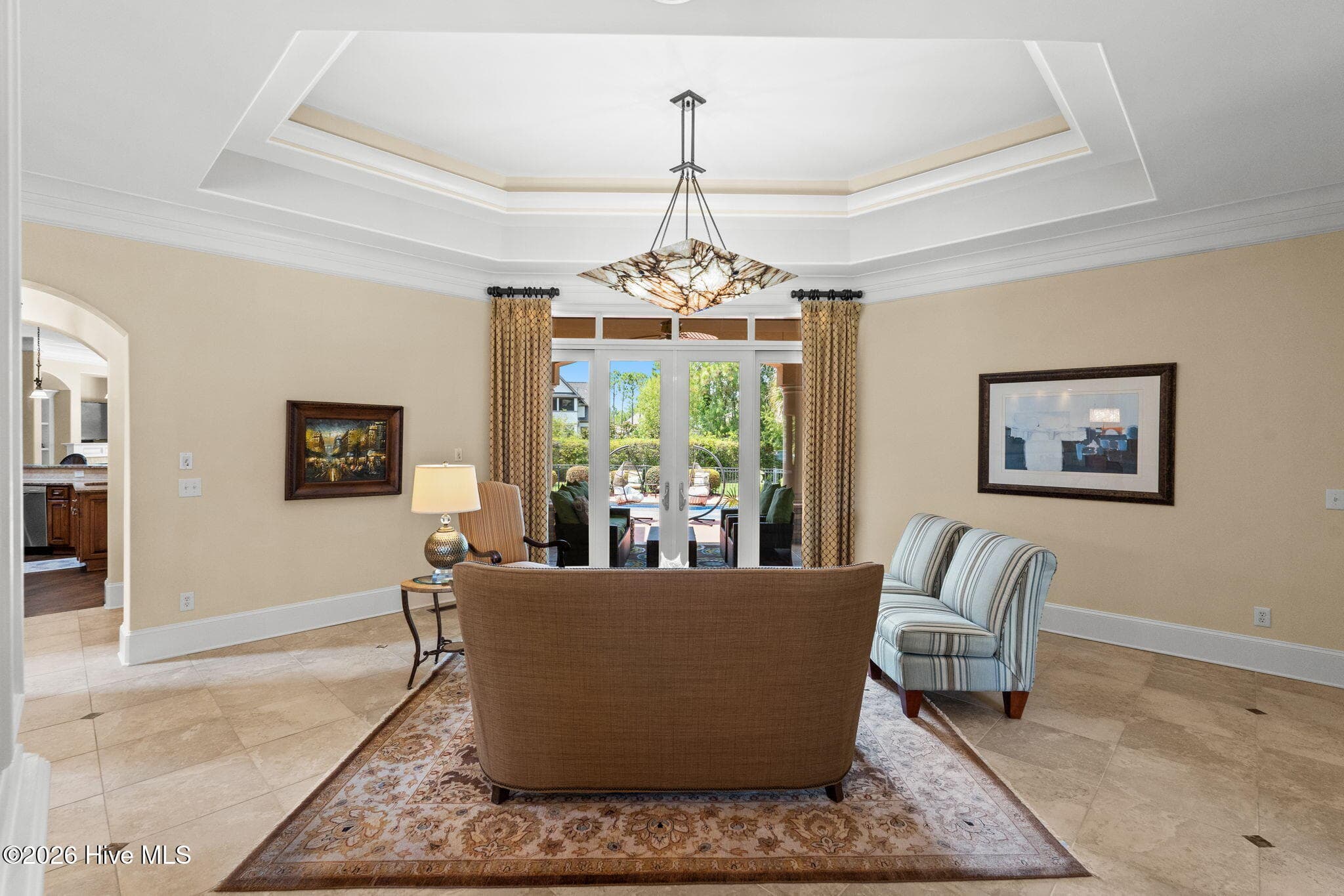 View of living room with sliders leading to pool area - 3858 Ridge Crest Drive, Southport, NC 28461