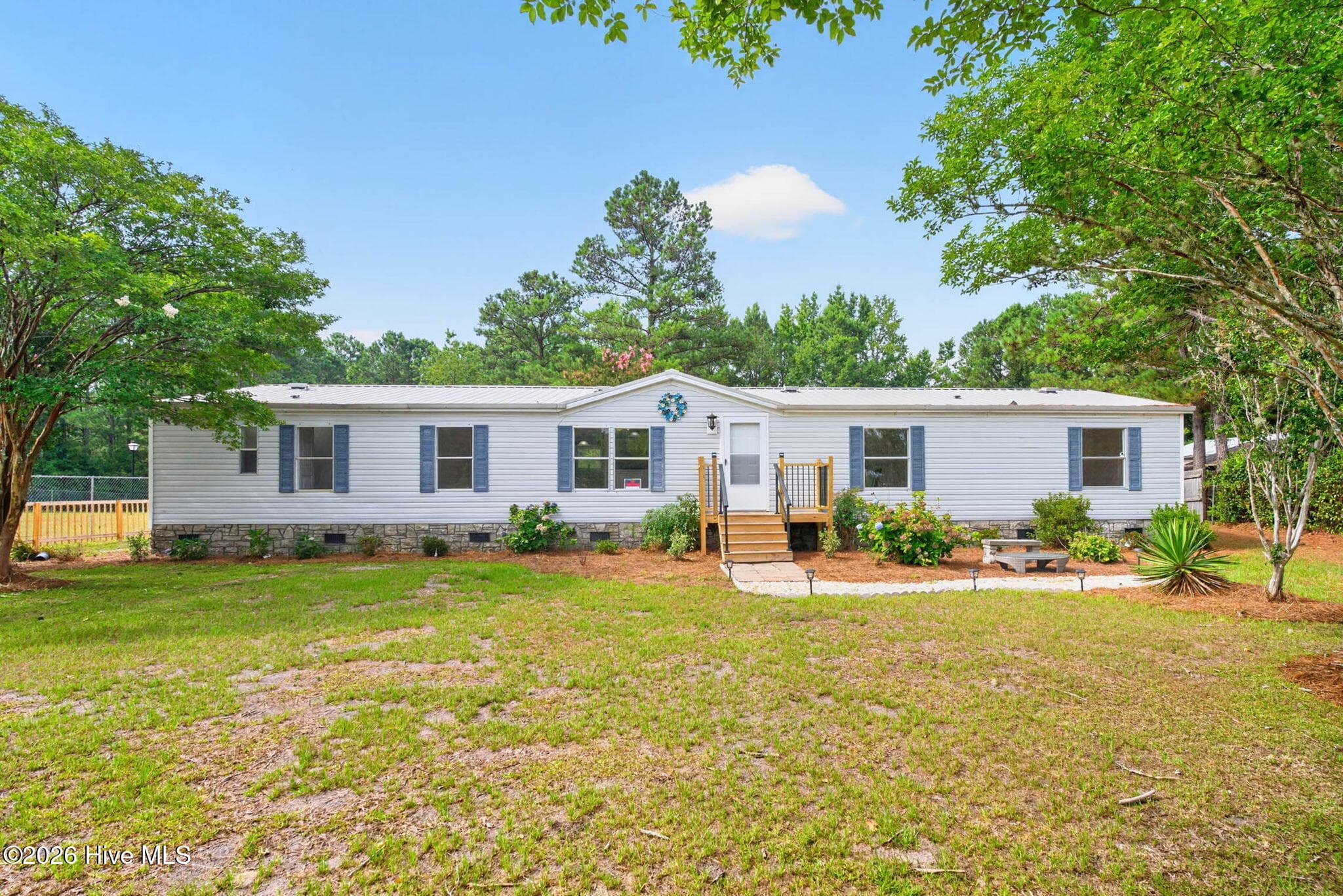 Beautifully renovated 4-bedroom home situated on a spacious, landscaped 0.57-acre lot with inviting curb appeal, mature trees, and a welcoming front porch. - 1199 Zack Street SE, Bolivia, NC 28422