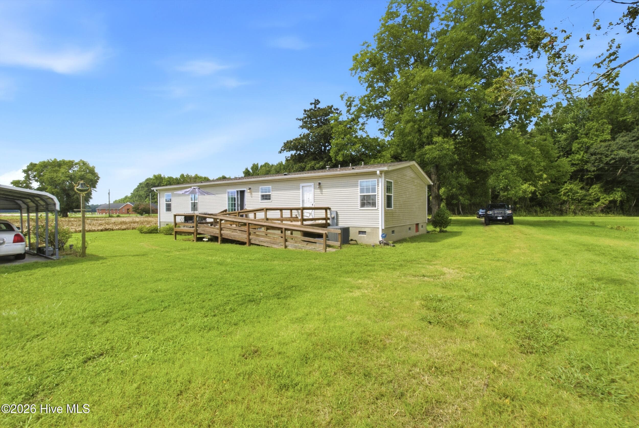 Rear of home with ramp and deck - 1230 Beech Springs Road, Tyner, NC 27980