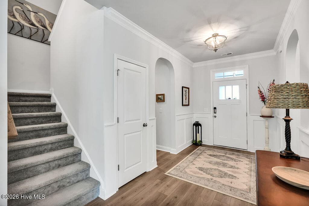 Make your way to the second floor via this staircase to reach the third bedroom, third bath, large open bonus room and expanded floored attic storage. - 142 Rice Marsh Way, Wilmington, NC 28412