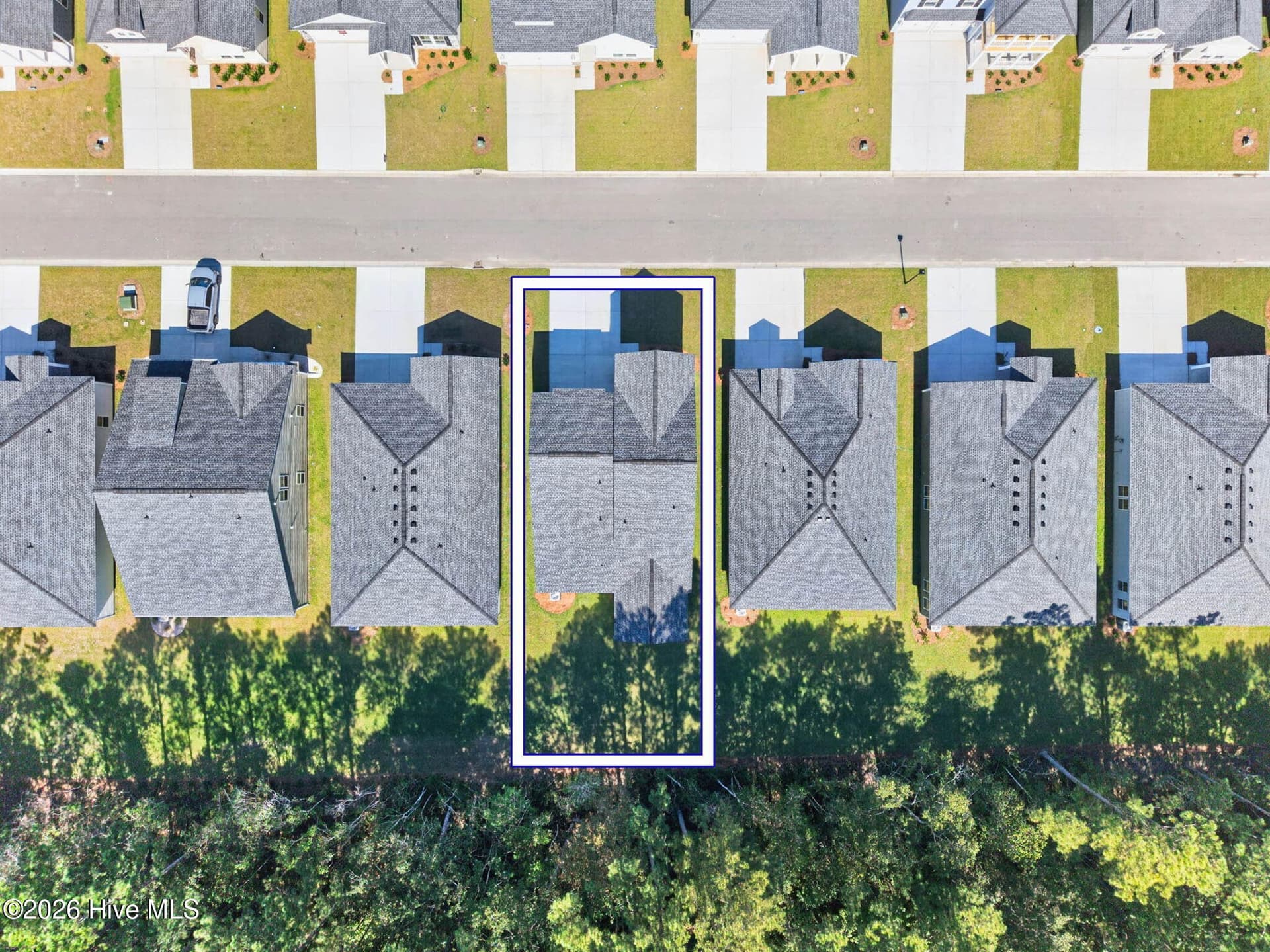 Overhead aerial view outlining the homesite and its location backing to a wooded common area. - 3447 Sandhill Crane Drive SW, Ocean Isle Beach, NC 28469