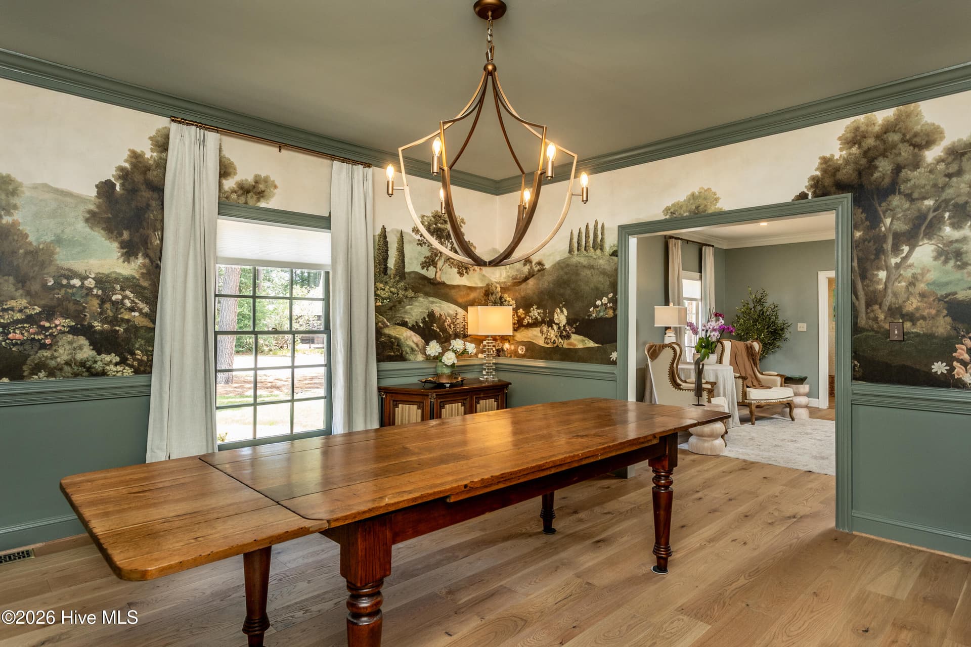 Old World Charm in this large dining room with beautiful wallpaper mural and fabulous chandelier. - 5050 Country Club Drive N, Wilson, NC 27896