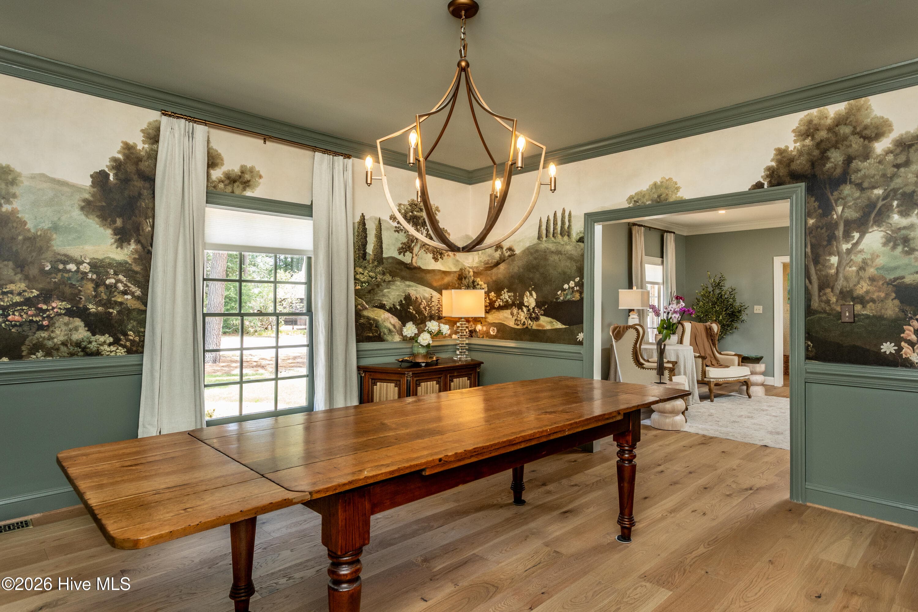 Old World Charm in this large dining room with beautiful wallpaper mural and fabulous chandelier. - 5050 Country Club Drive N, Wilson, NC 27896
