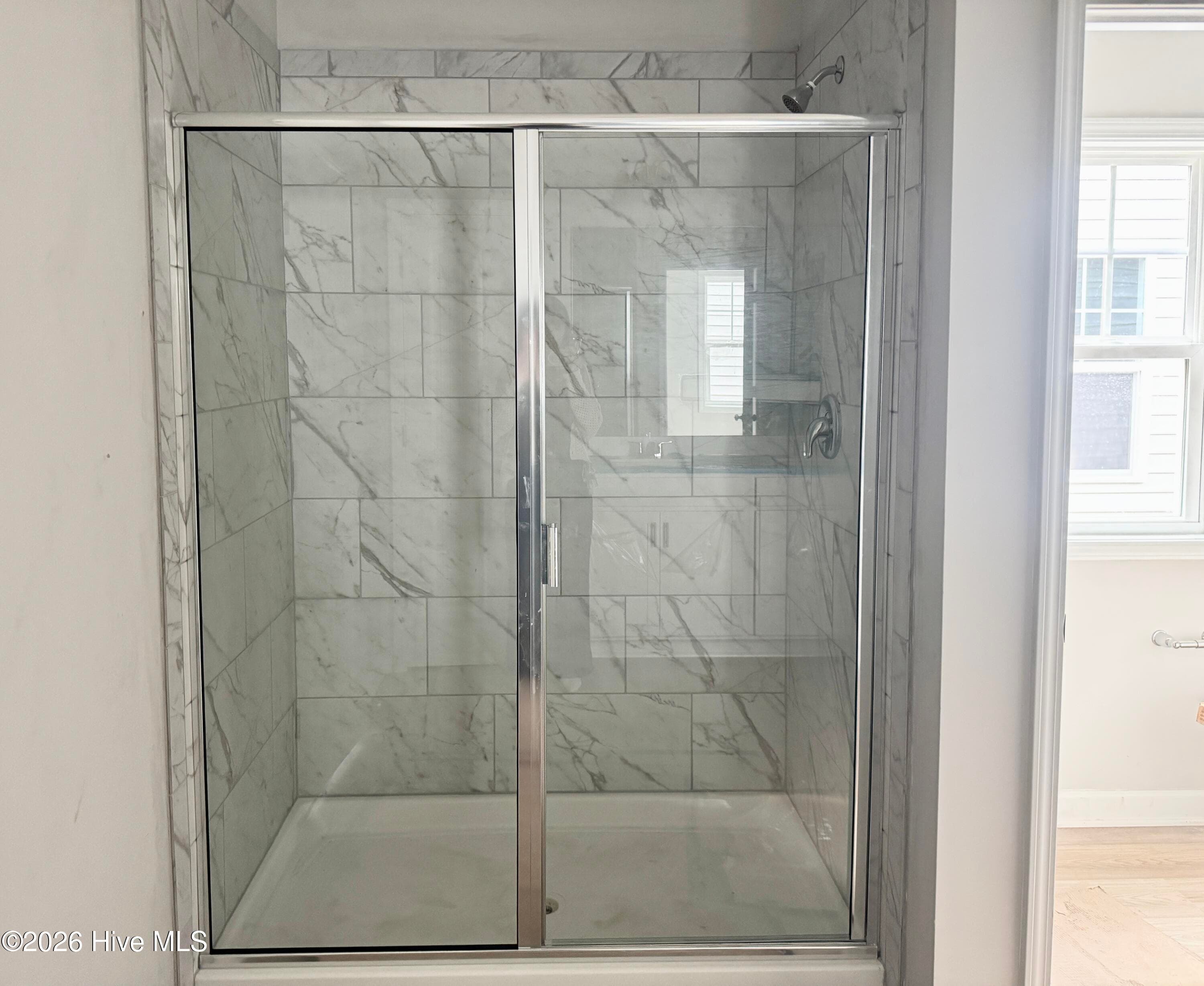 Primary Suite features a Private Bathroom with Tile Shower and Large Walk-in Closet - 4188 Workman Loop 89, Leland, NC 28451