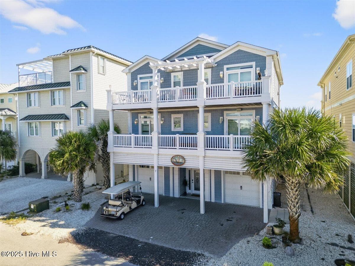 Street side view of 7 Coggleshall with driveway parking for 3 vehicles. - 7 Coggeshall Drive W, Ocean Isle Beach, NC 28469