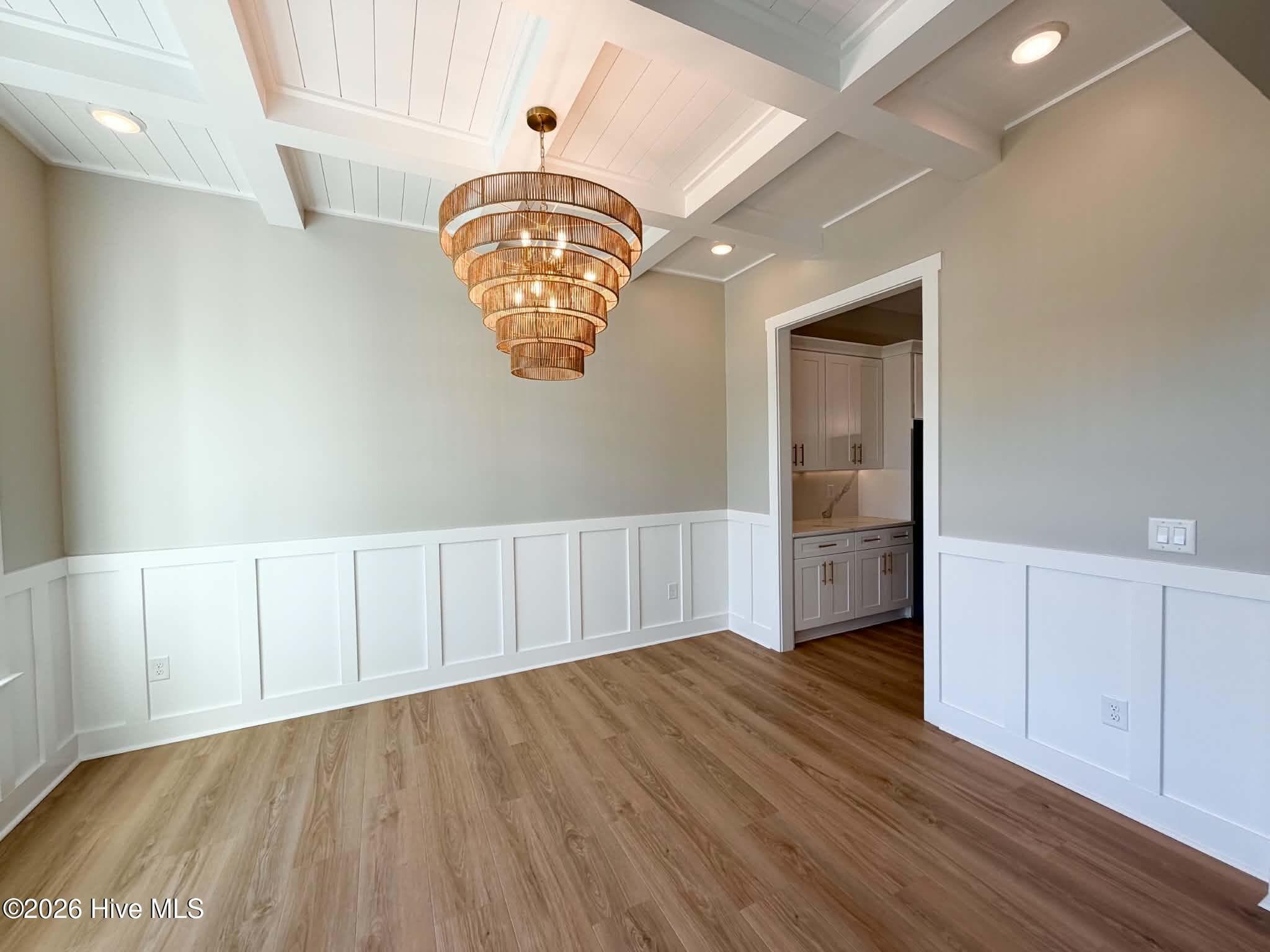 Dining room with custom lighting, wainscoting and coffered ceiling. - 550 Glenburnie Street NW, Calabash, NC 28467