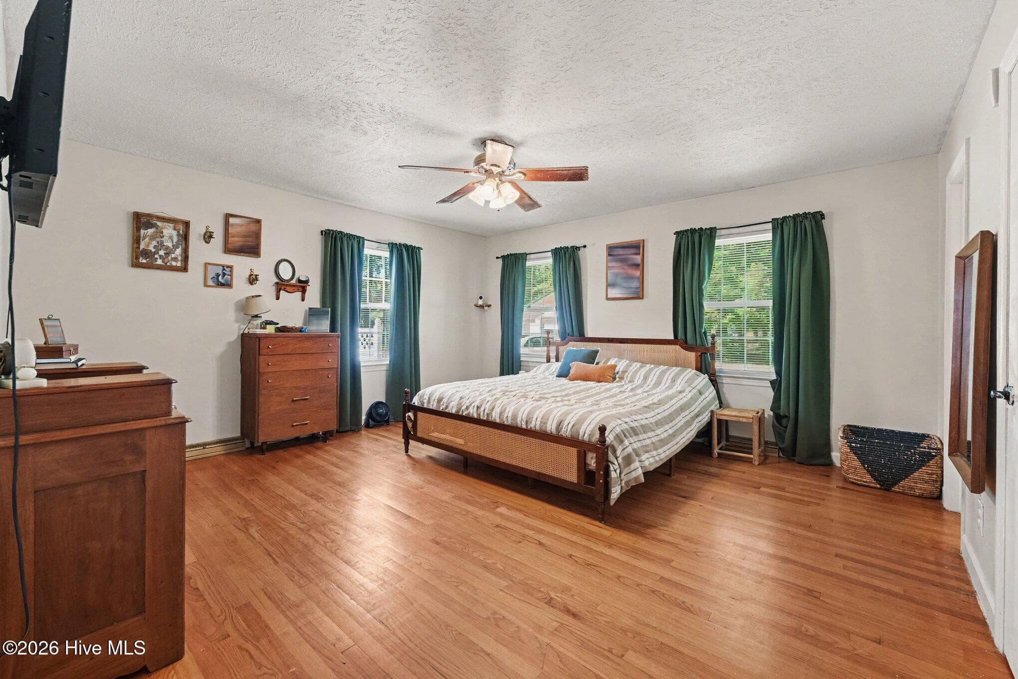 Large primary bedroom with ceiling fan and hardwood floors - 1017 S Claiborne Street, Goldsboro, NC 27530