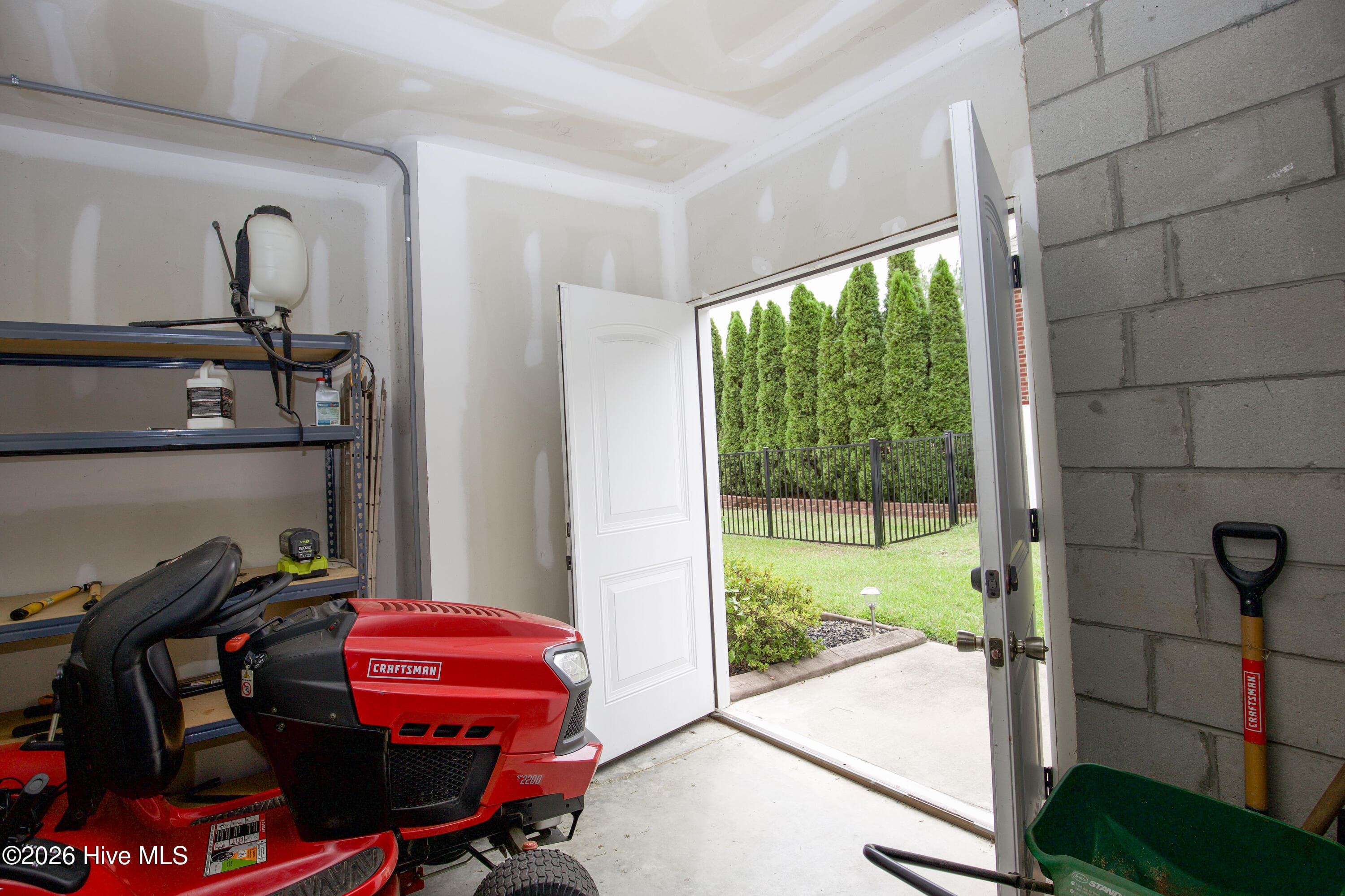 Basement storage room with an exterior door, useful for lawn equipment. - 899 Seagull Drive, Vass, NC 28394, Vass