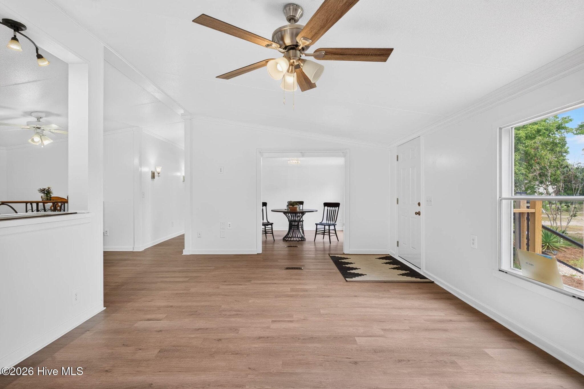 The open-concept living area seamlessly connects the living room, dining space, and kitchen, creating an ideal setting for entertaining family and friends. - 1199 Zack Street SE, Bolivia, NC 28422