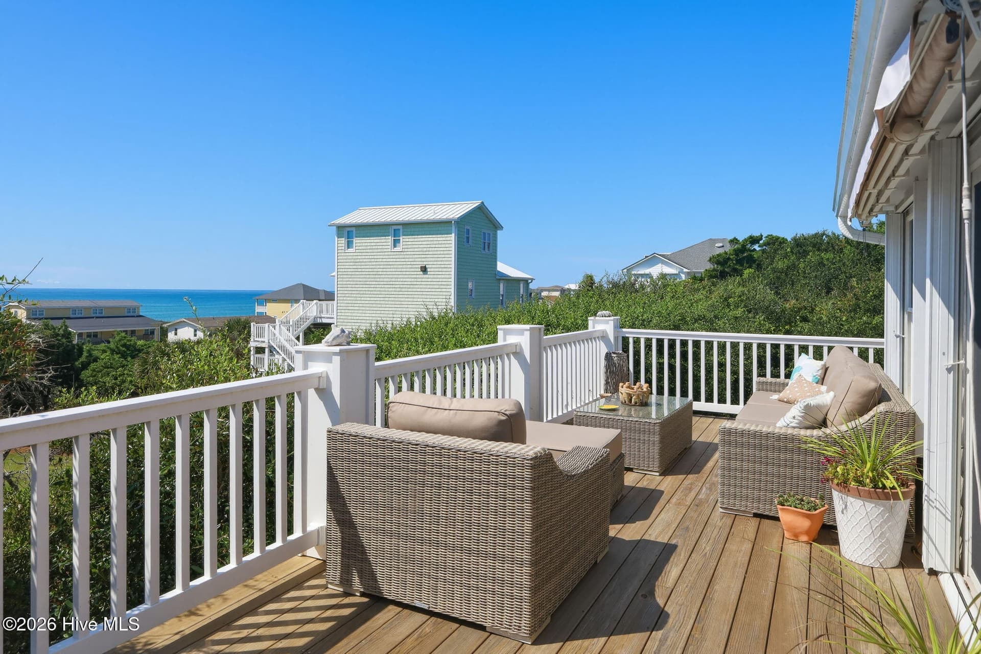 Expansive 10-foot-deep decks provide exceptional outdoor living space for entertaining, dining, or simply enjoying island life. - 103 Georgia Street, Emerald Isle, NC 28594