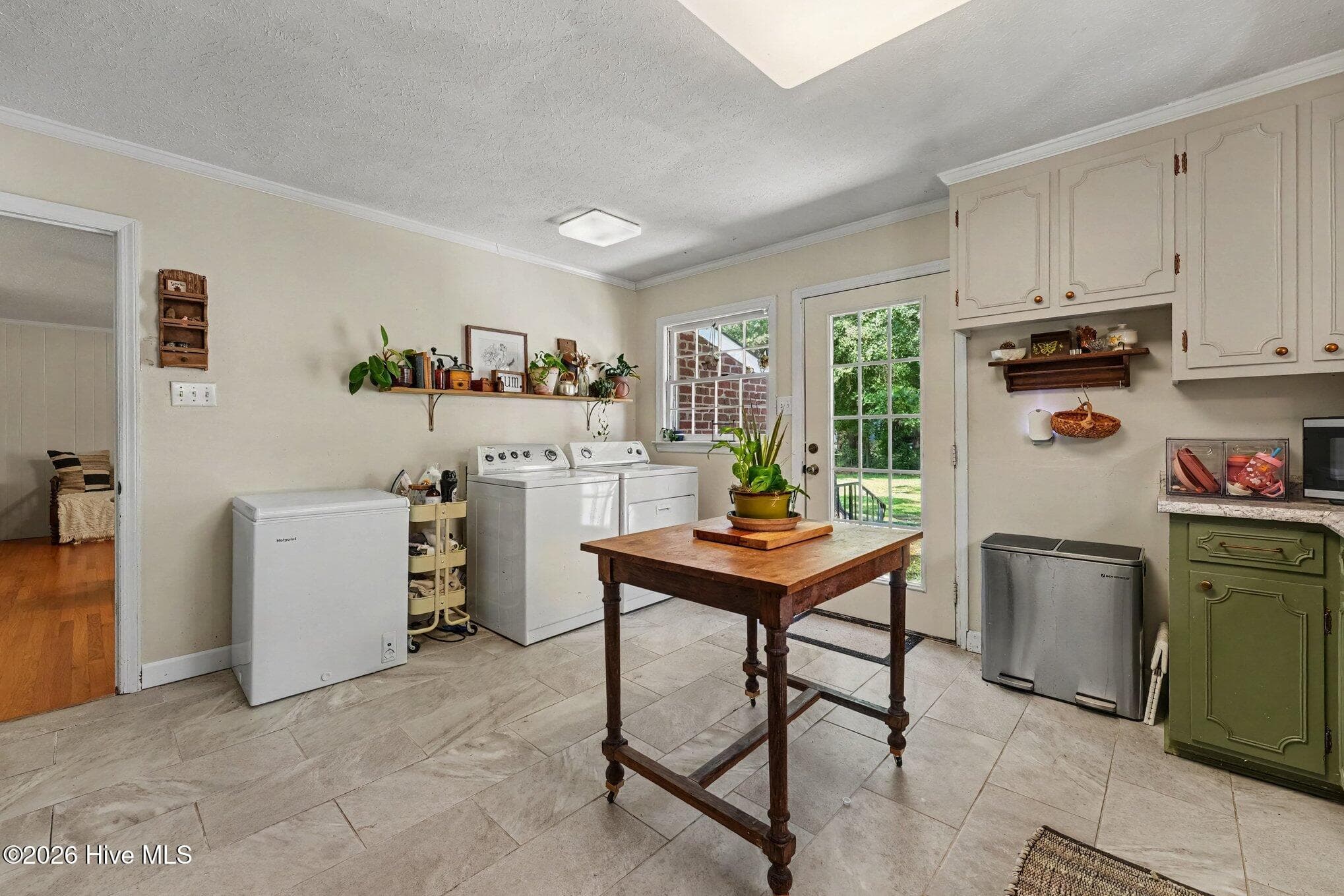 Kitchen view with laundry area and display shelf. - 1017 S Claiborne Street, Goldsboro, NC 27530