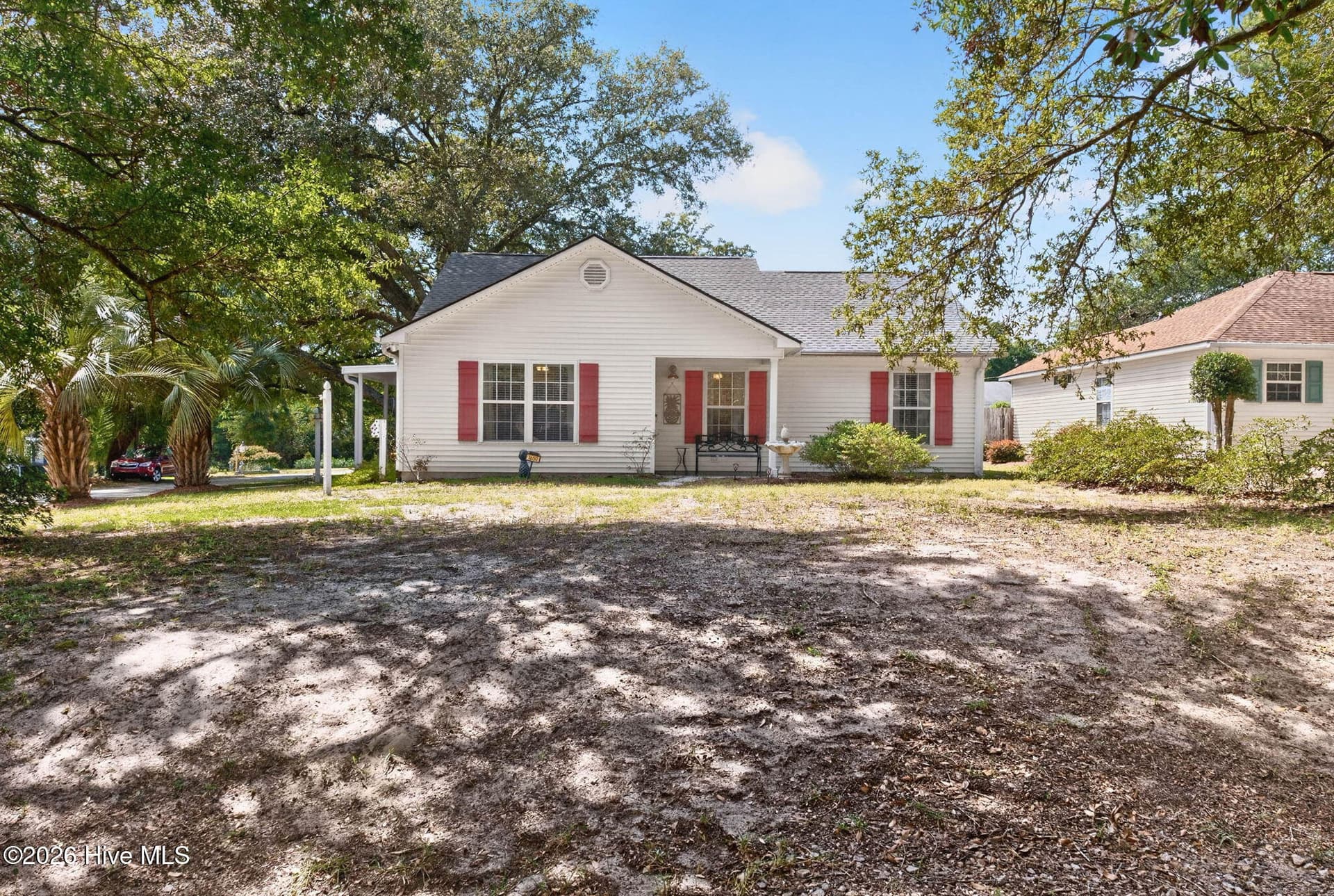 Charming coastal exterior framed by mature trees in a convenient mainland Ocean Isle Beach location. - 1650 Frink Street SW, Ocean Isle Beach, NC 28469