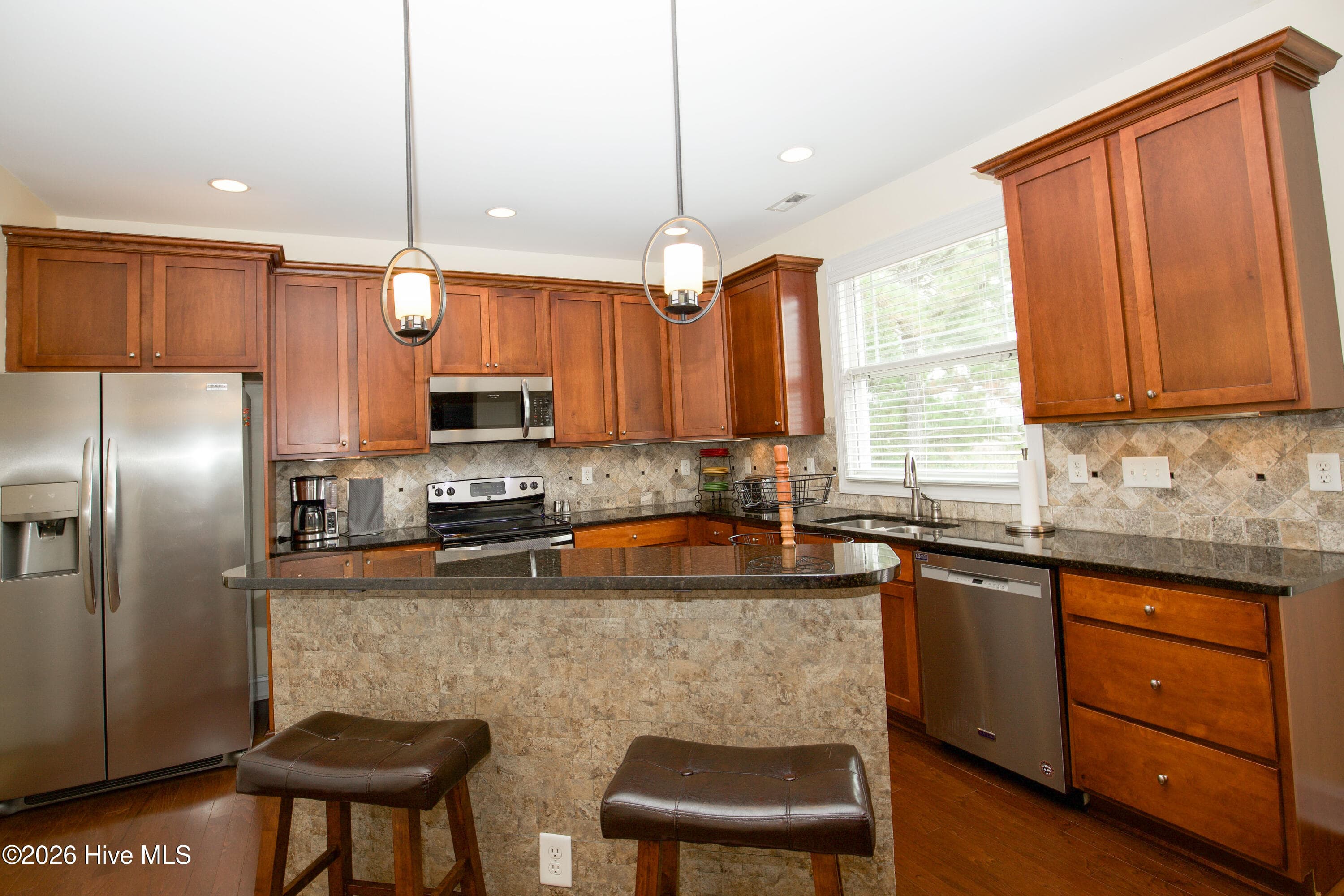 Kitchen with a center island, pendant lighting, and stainless appliances. - 899 Seagull Drive, Vass, NC 28394, Vass