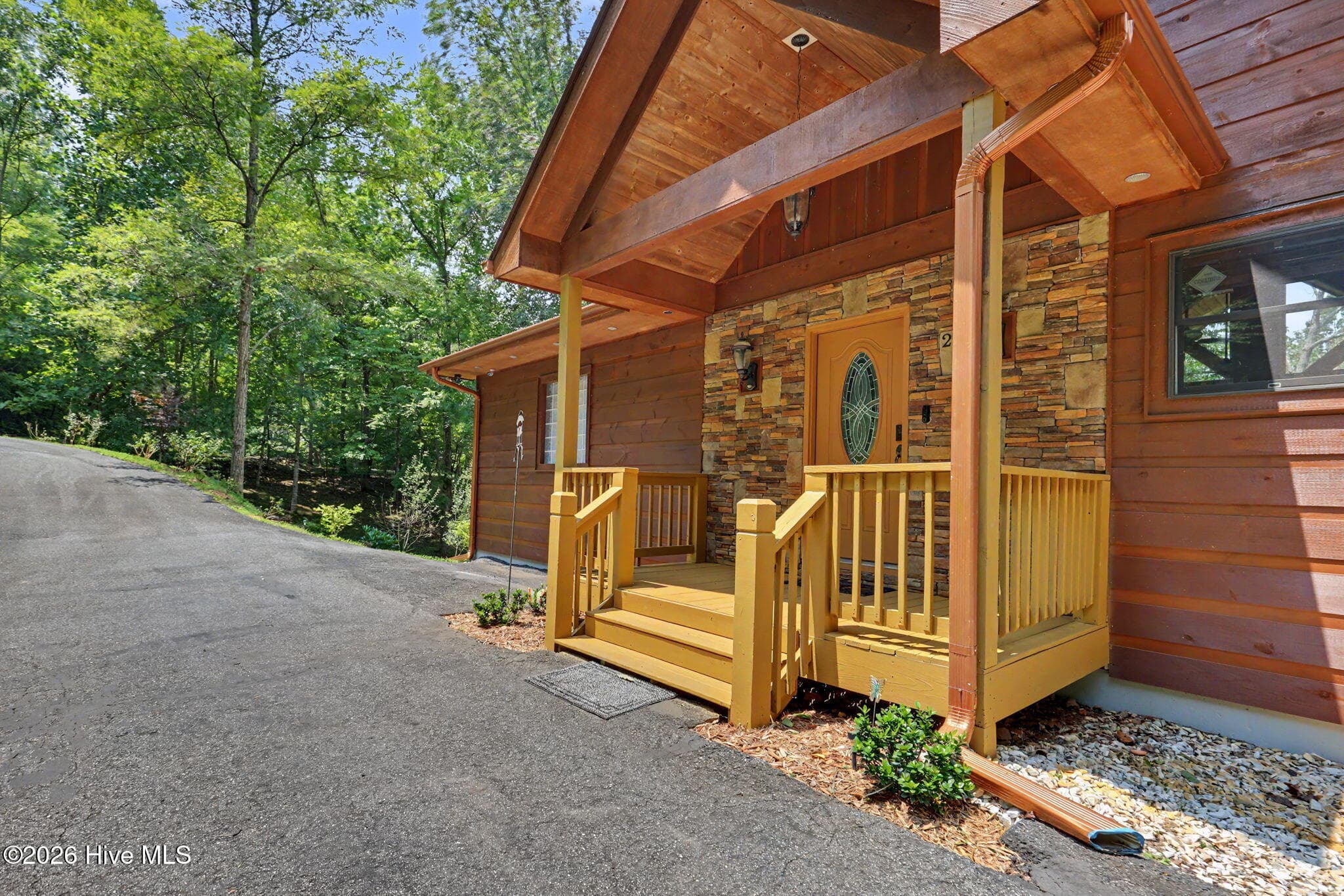 Welcoming timber-framed entrance with stacked stone accents. - 210 Majestic Drive, Hayesville, NC 28904
