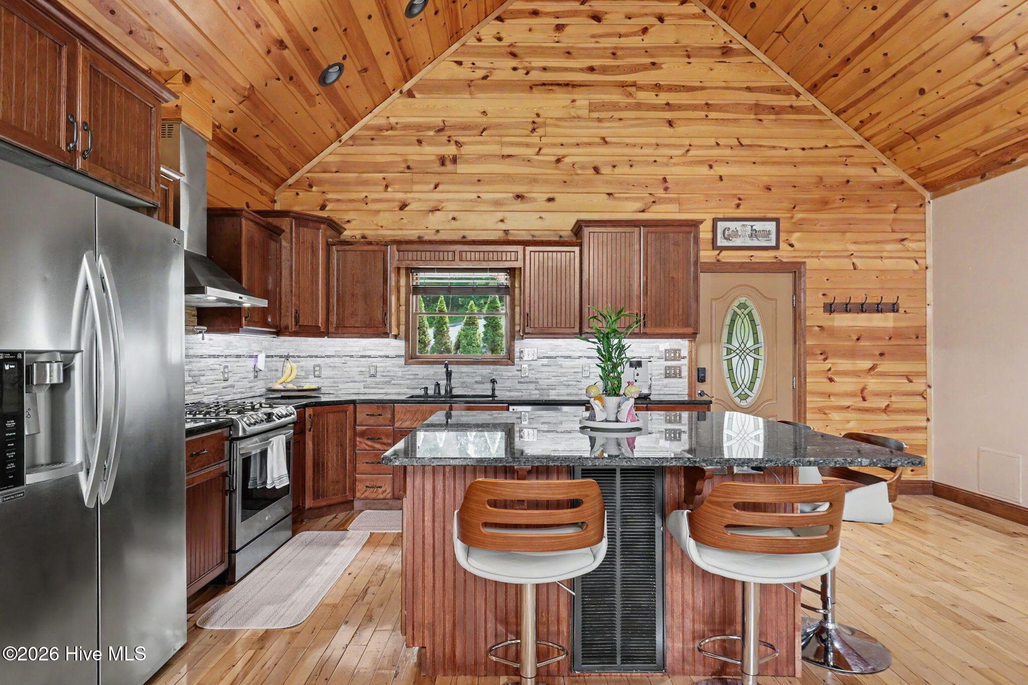 Warm wood cabinetry and tongue-and-groove ceilings enhance the mountain character. - 210 Majestic Drive, Hayesville, NC 28904