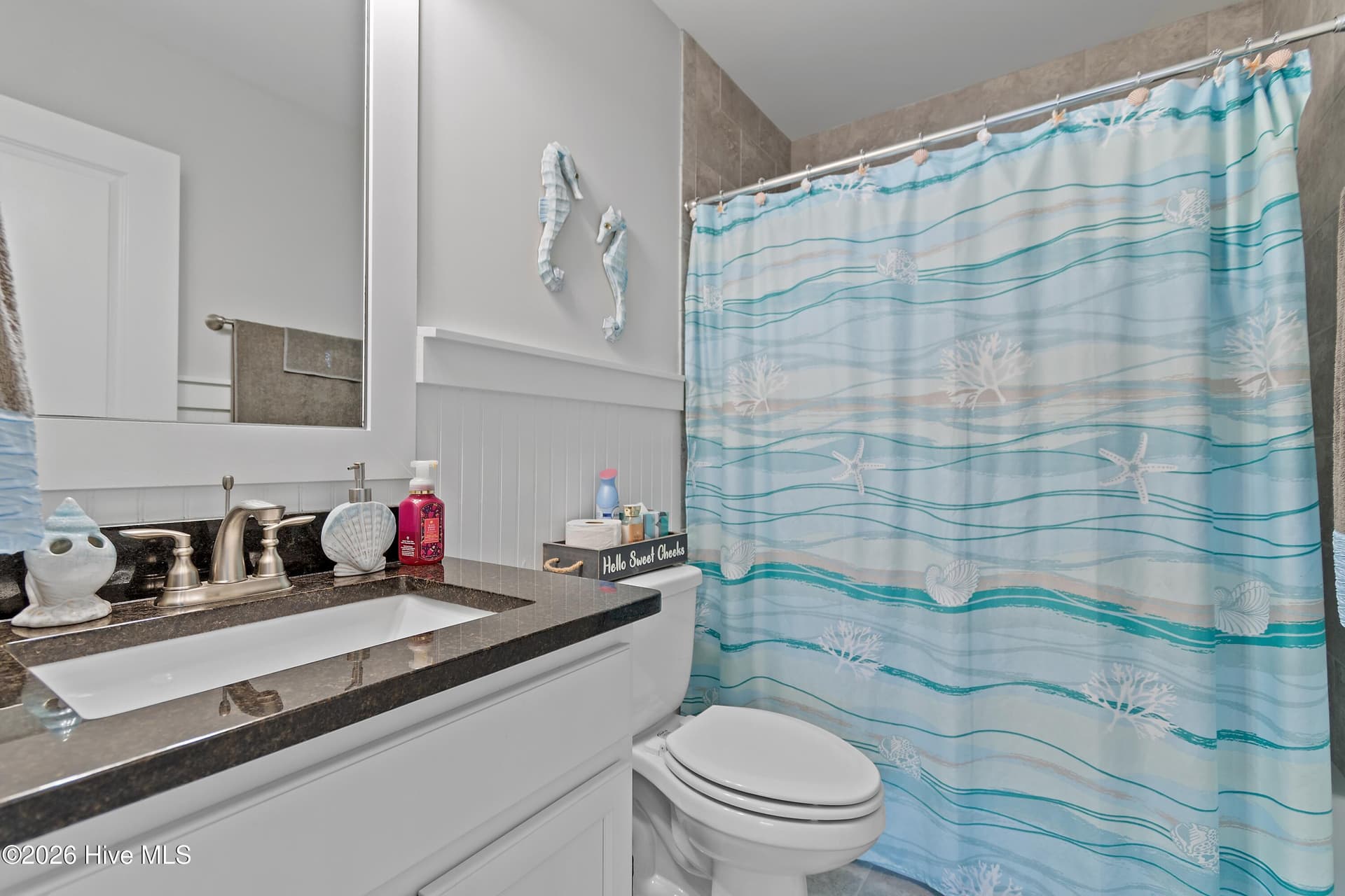 Second floor bathroom. Notice the same beadboard and granite countertops as in other bathrooms. - 6358 Bryson Drive SW, Ocean Isle Beach, NC 28469