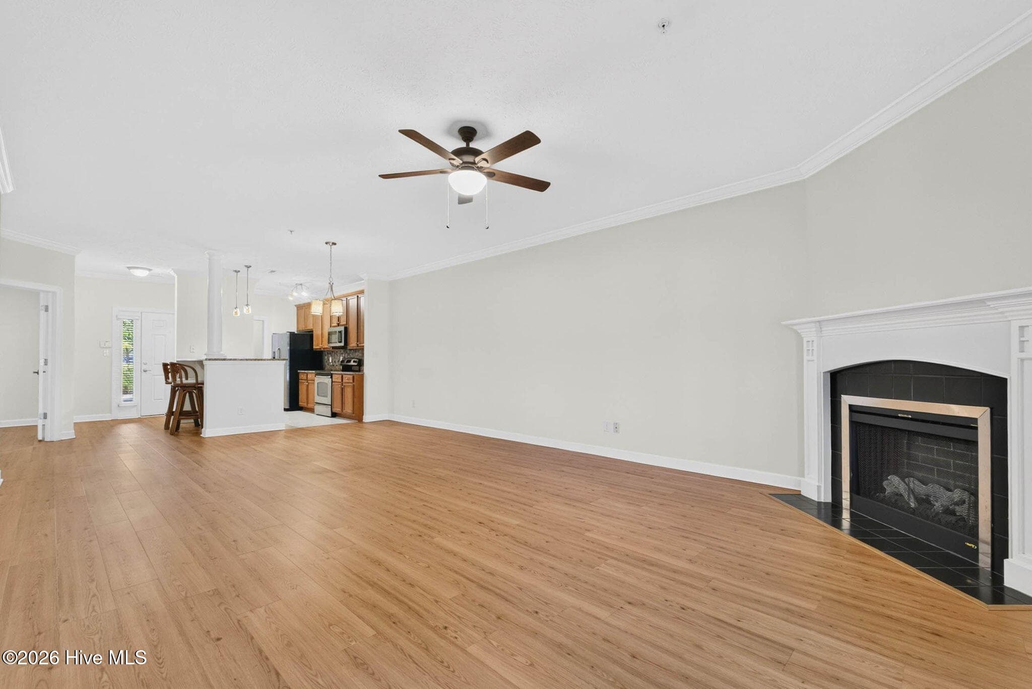 View of living room, to dining room, and then into the kitchen - 7825 High Market Street #303, Sunset Beach, NC 28468