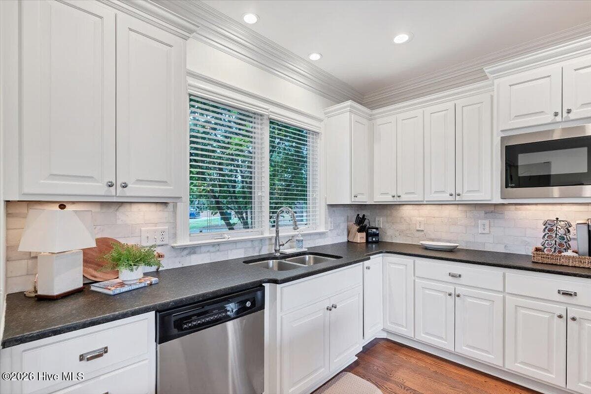 The heart of the home is beautifully updated, featuring crisp white cabinetry. - 150 Cochrane Castle Circle, Pinehurst, NC 28374
