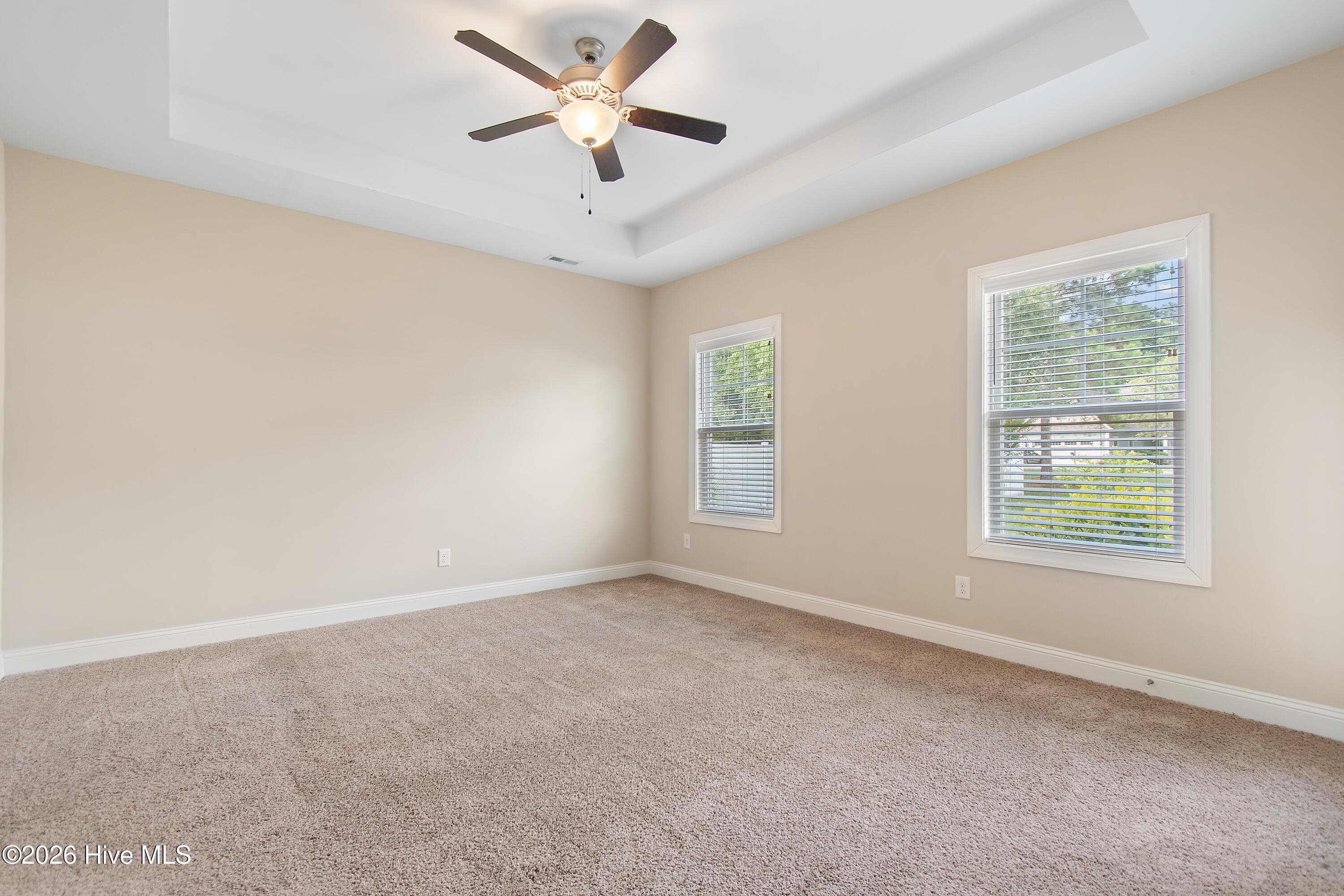 Primary suite with tray ceiling. - 1674 Back Bay Drive SW, Shallotte, NC 28470
