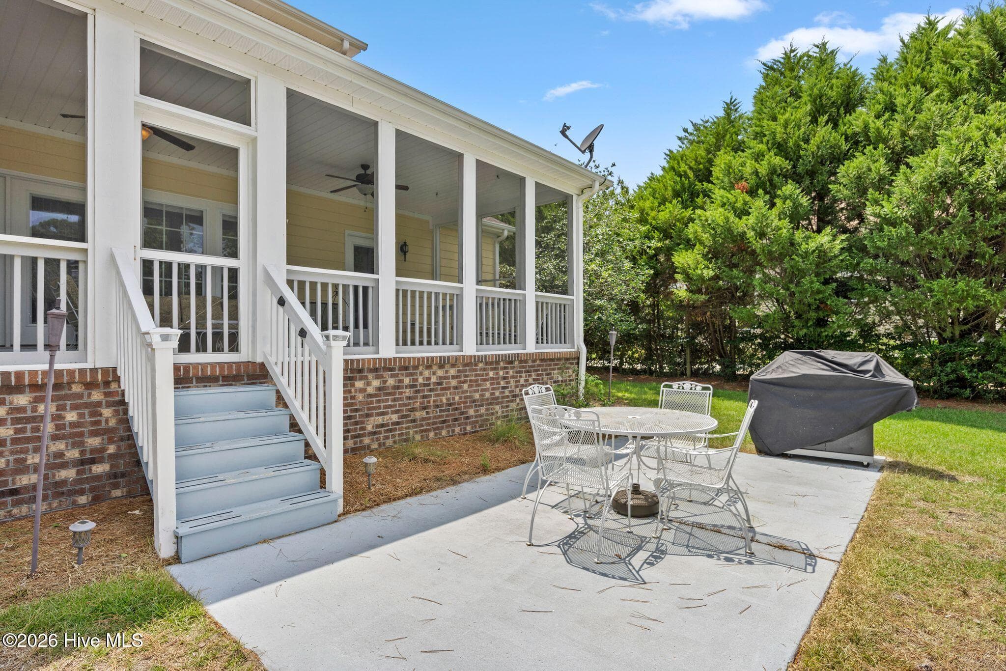 Large paved patio off the rear deck. Note gas connected grill will convey! - 1620 Golfers Ridge Drive SE, Bolivia, NC 28422