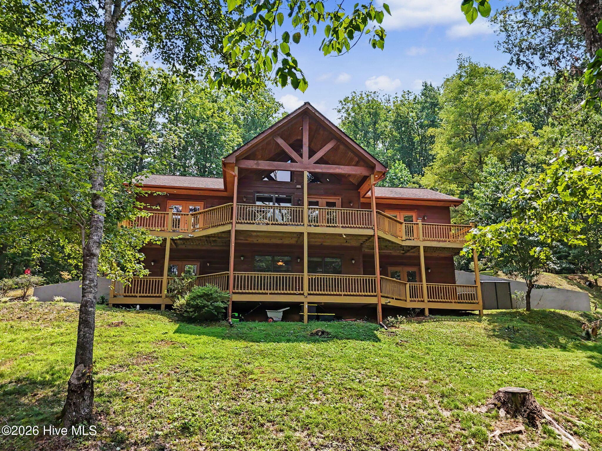 Custom mountain home on 3.93 private acres in gated Lakeview Heights, with Expansive two-level covered decks overlook the peaceful wooded setting. - 210 Majestic Drive, Hayesville, NC 28904