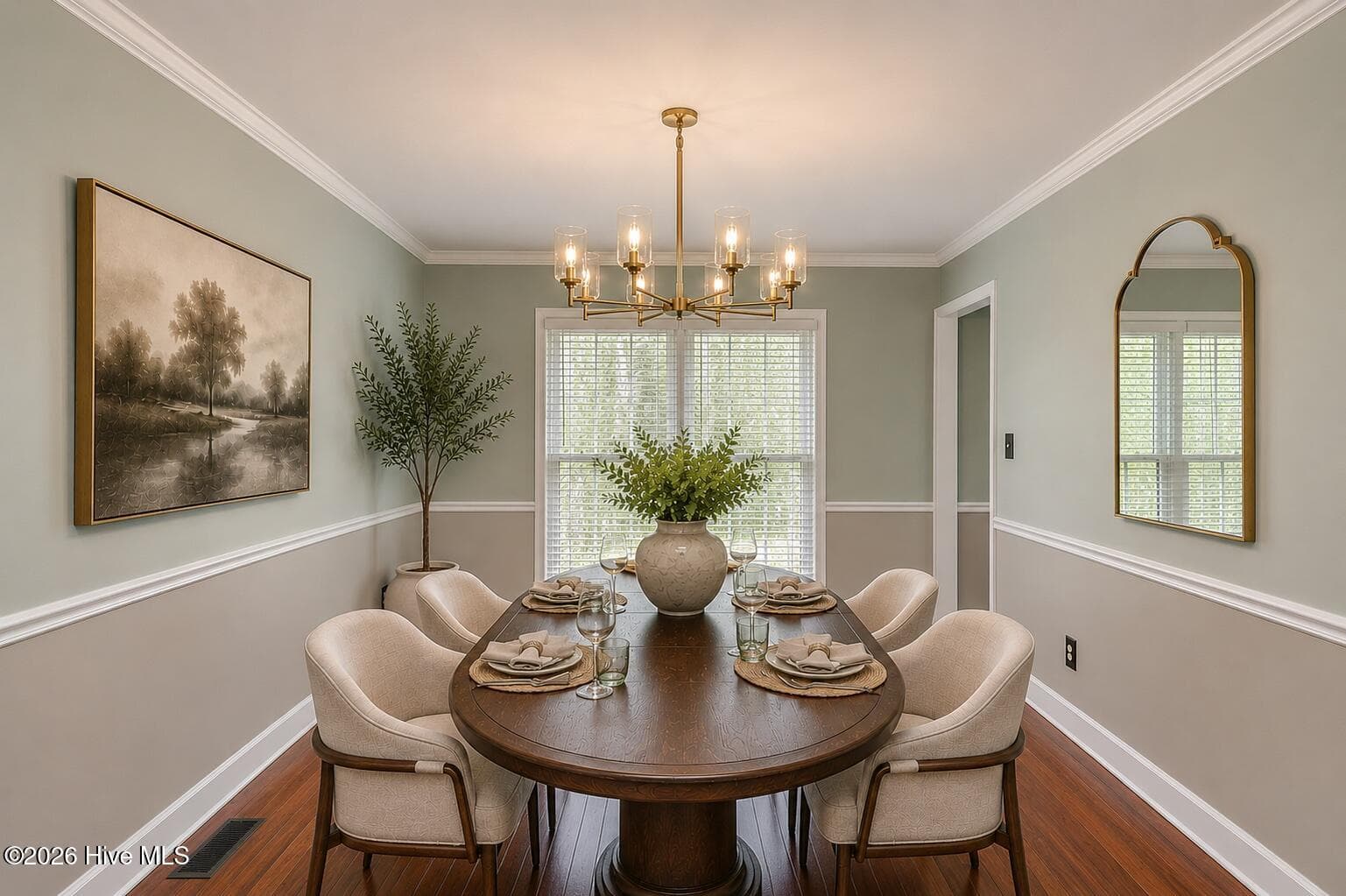 An elegant dining room with warm hardwood floors, beautiful natural light, and a timeless setting for everyday meals or special gatherings. - 16 Rapids Court, North Augusta, SC 29841