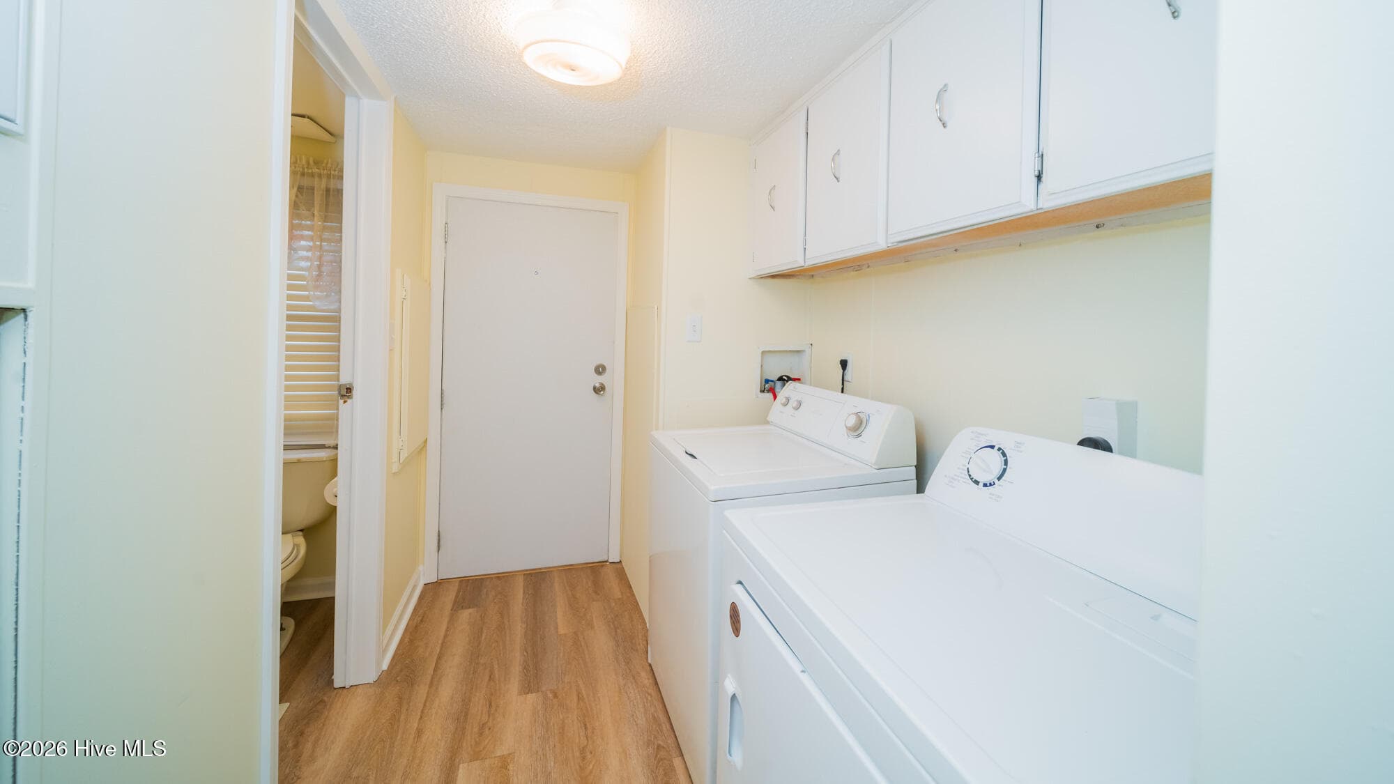 The laundry room features lots of storage cabinets. - 1076 Clubview Lane SW, Calabash, NC 28467
