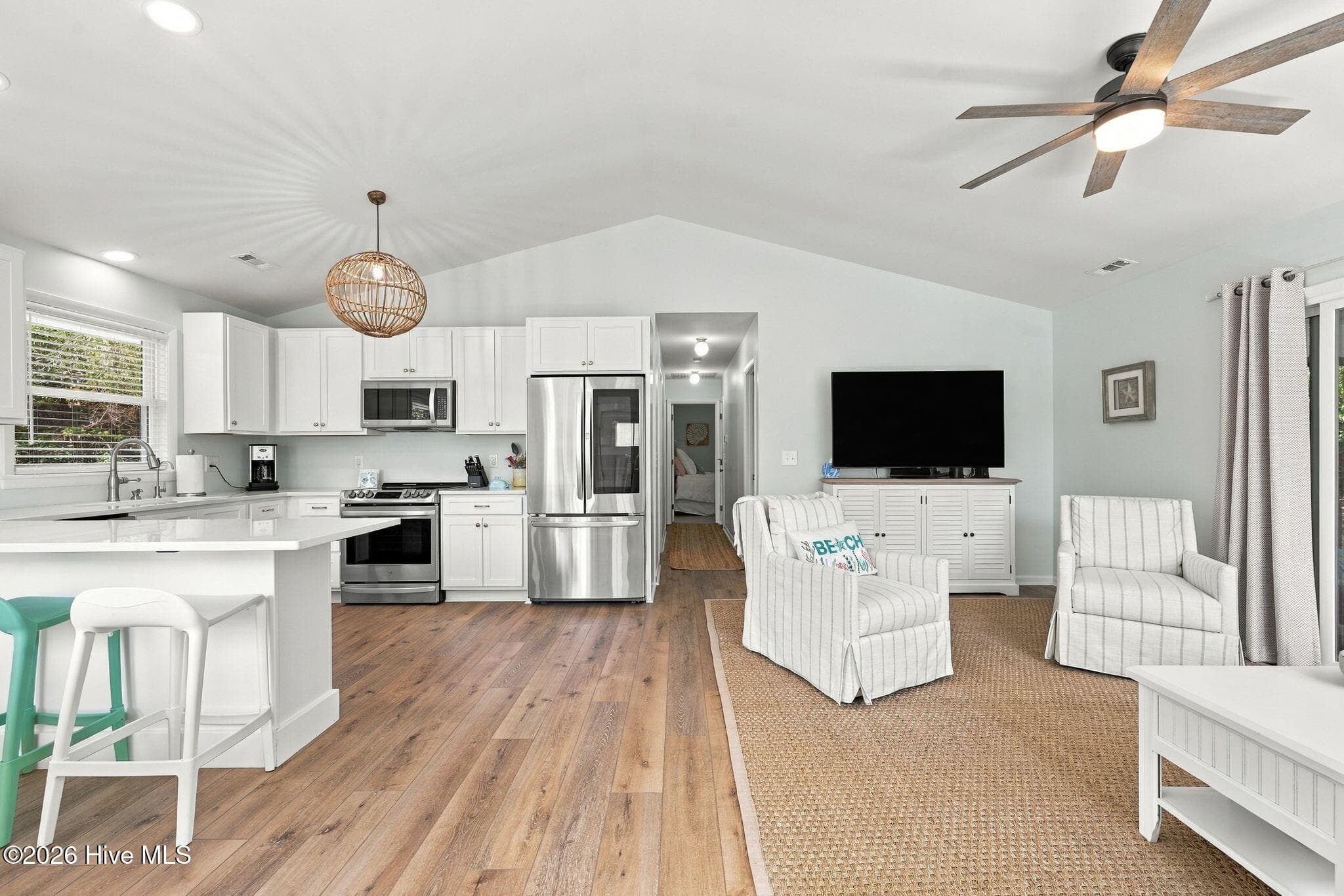 Open living room and kitchen with vaulted ceiling - 118 Periwinkle Drive, Emerald Isle, NC 28594