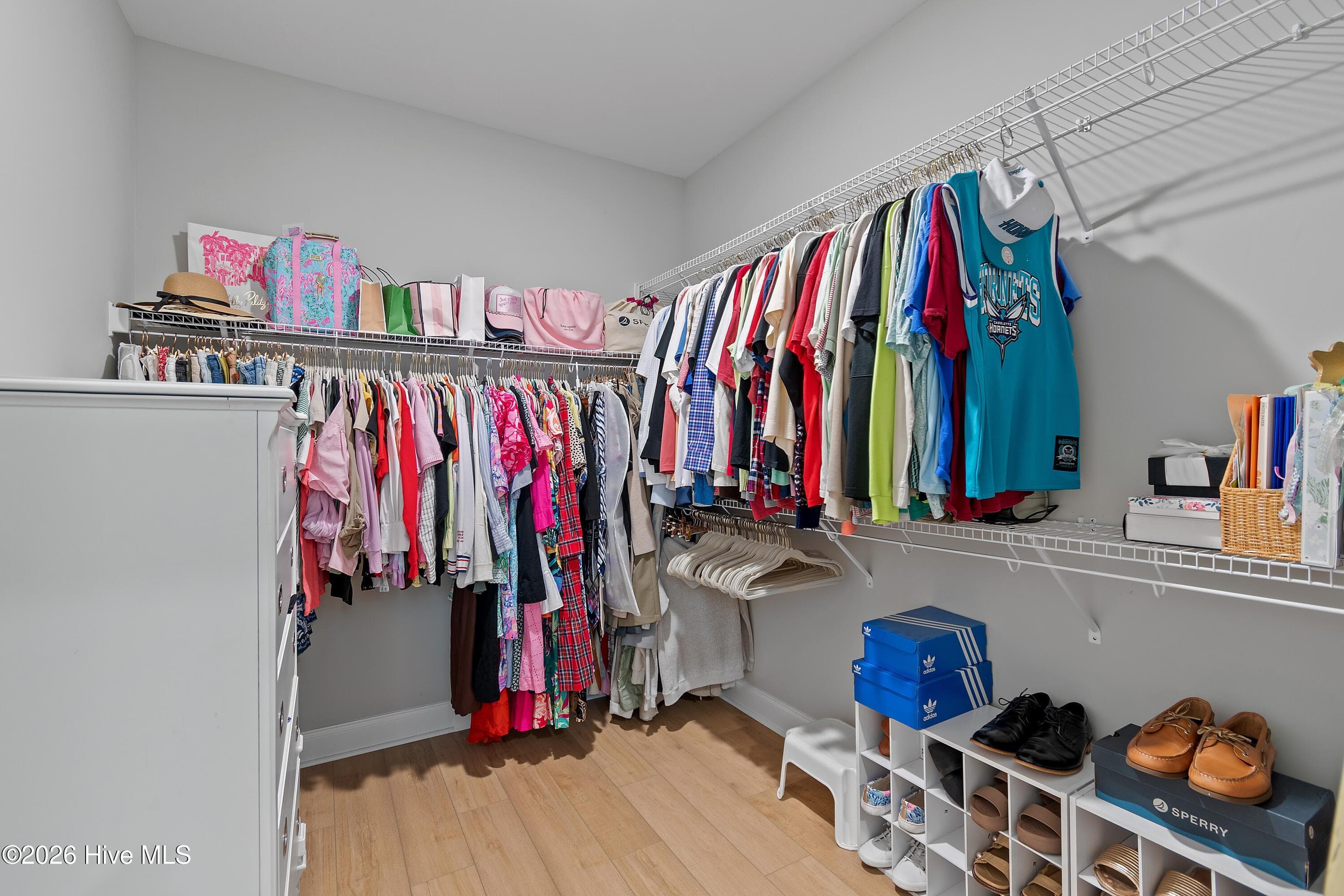 The owner’s suite features a spacious walk-in closet, offering ample storage and organization for clothing, shoes, and accessories while creating a comfortable and functional private retreat. - 299 Boundaryline Drive NW, Calabash, NC 28467