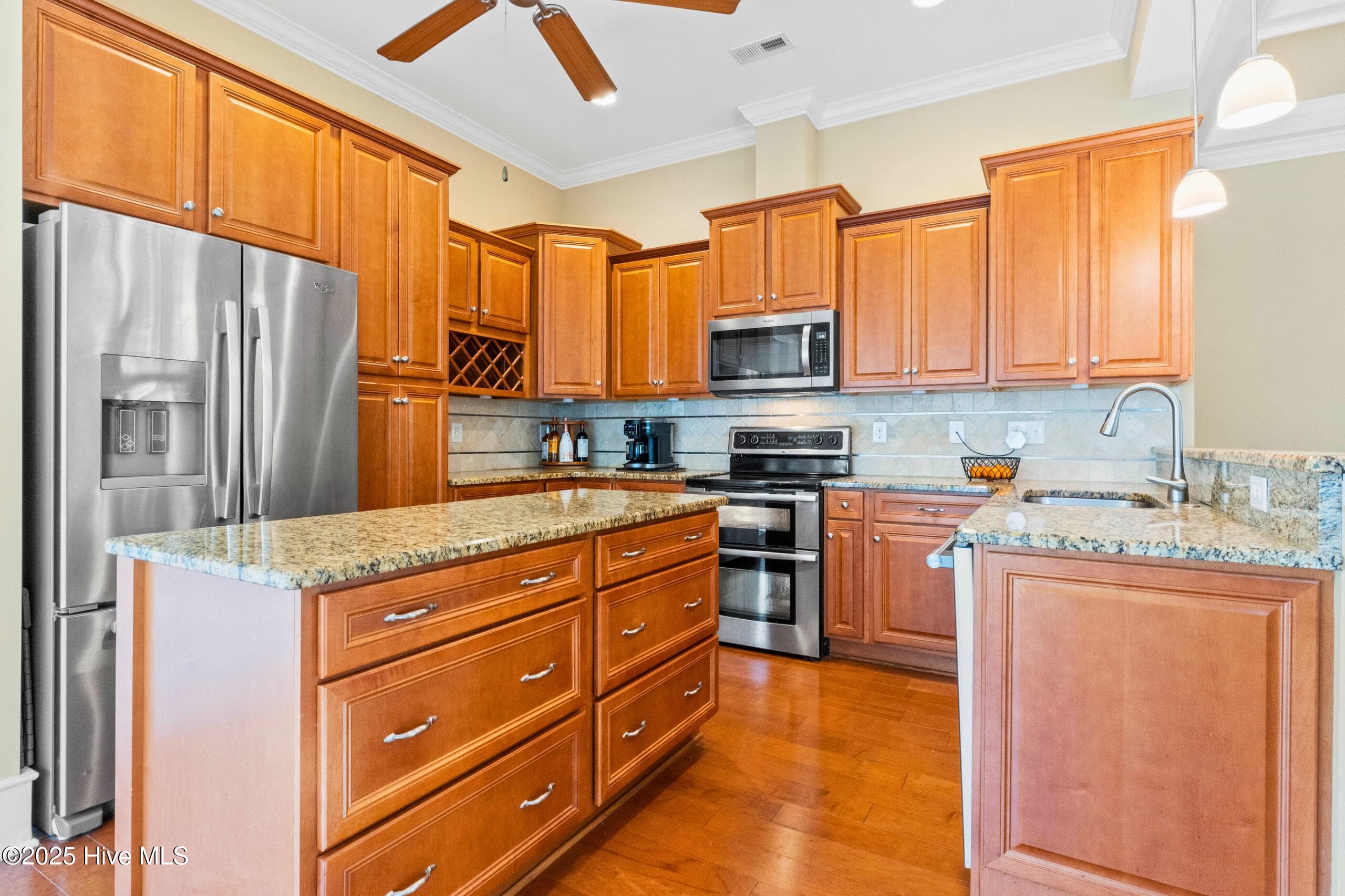 Gourmet kitchen featuring dynamic granite countertops, custom cabinetry, stainless steel appliances, and a central island built for entertaining. - 9100 Fountain Street SW, Calabash, NC 28467