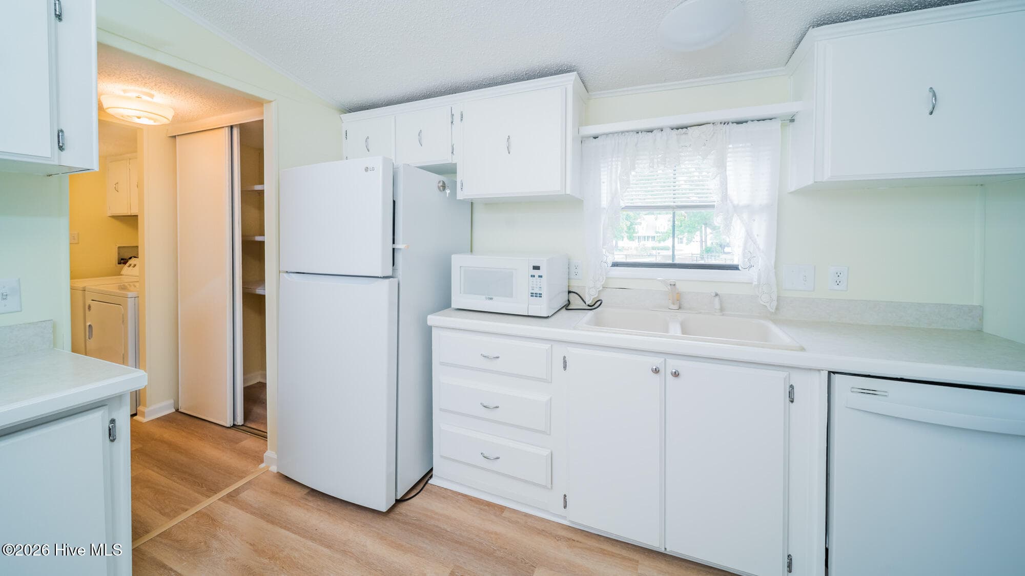 The kitchen conveniently joins the laundary room and provides a hall way to the primary bath. - 1076 Clubview Lane SW, Calabash, NC 28467