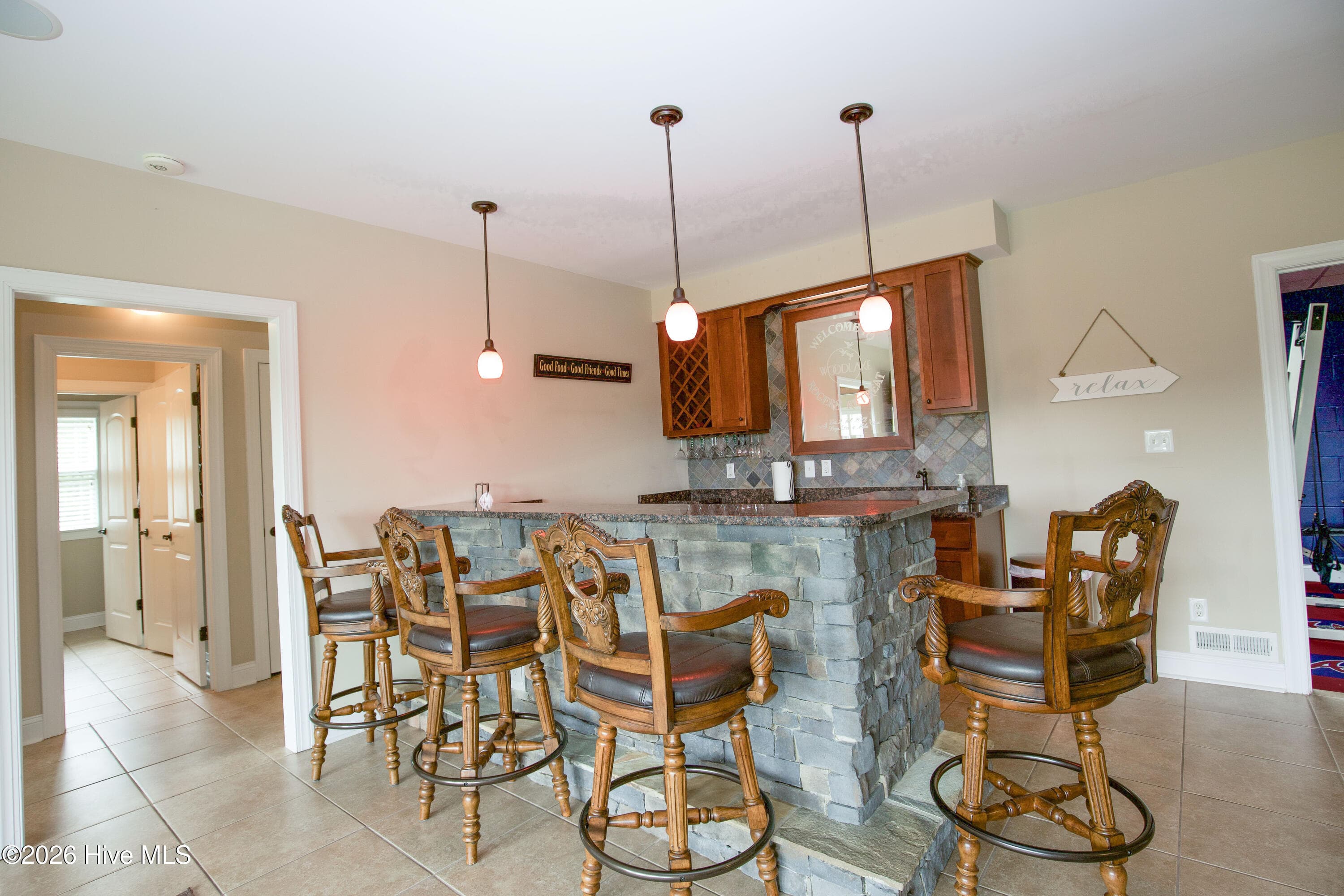 Wet bar seating with pendant lighting. - 899 Seagull Drive, Vass, NC 28394, Vass