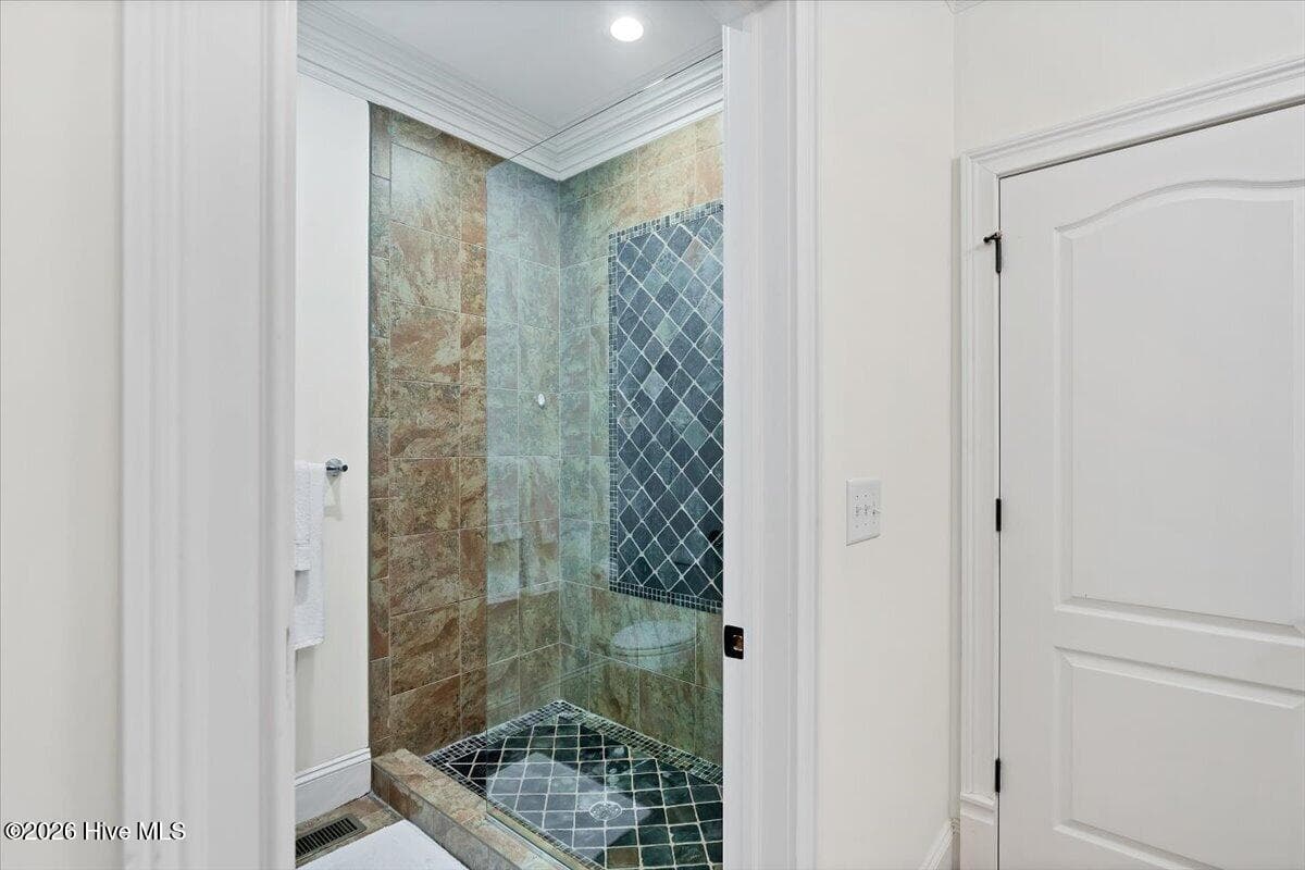 Beautifully Tiled Walk-In Shower with frameless glass...daily resort-style experience right at home - 150 Cochrane Castle Circle, Pinehurst, NC 28374
