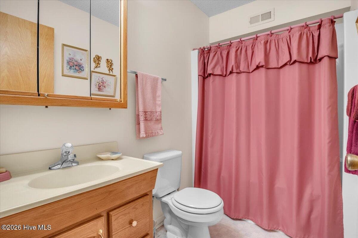 Second full bathroom on first floor - 109 NE 30th Street, Oak Island, NC 28465