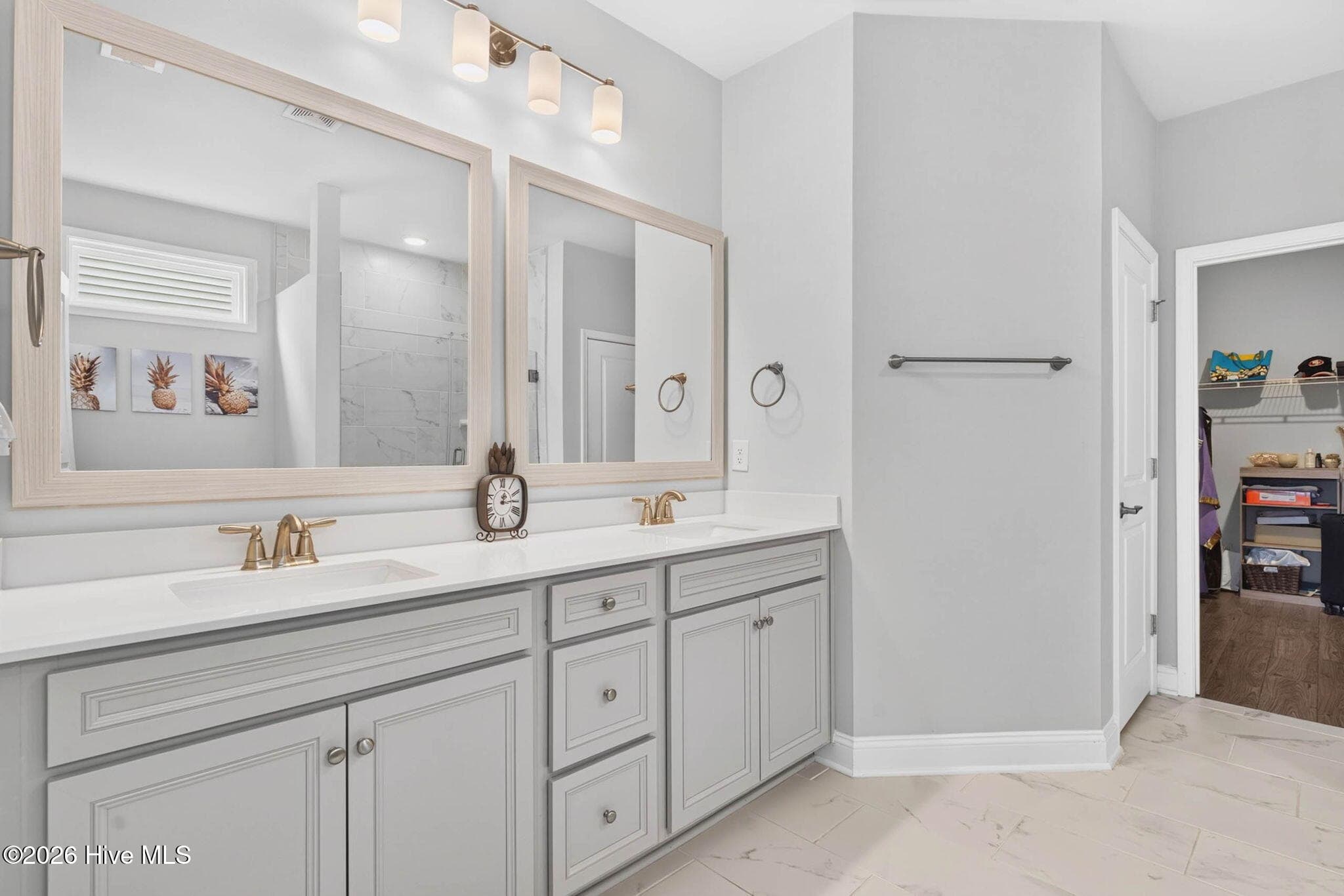 An extended vanity provides abundant countertop space, cabinetry, and storage in the spacious primary bathroom. - 139 Eagle Claw Drive, Calabash, NC 28467