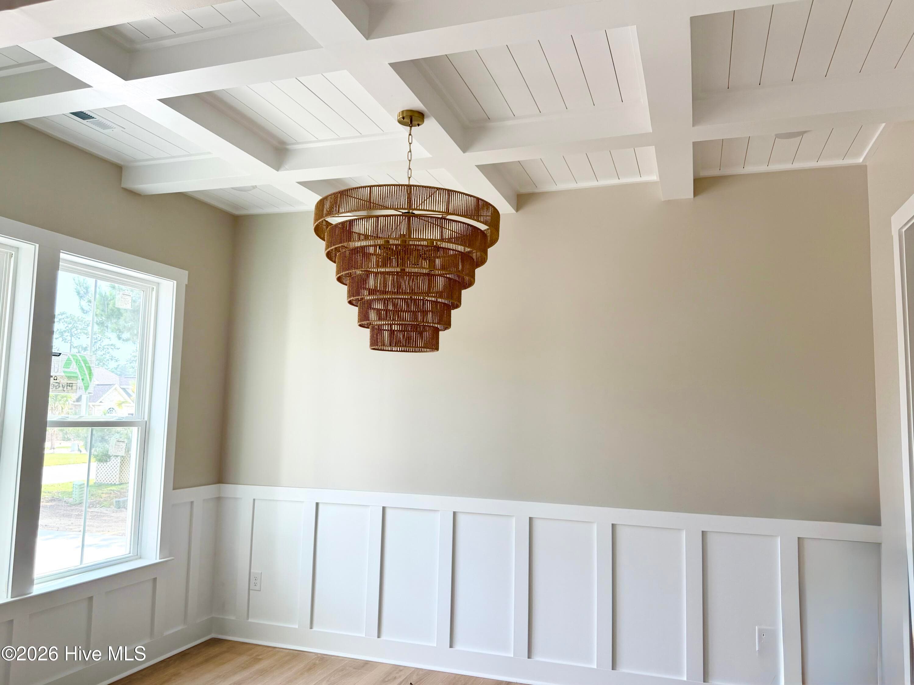 Dining room with custom lighting, wainscoting and coffered ceiling. - 550 Glenburnie Street NW, Calabash, NC 28467