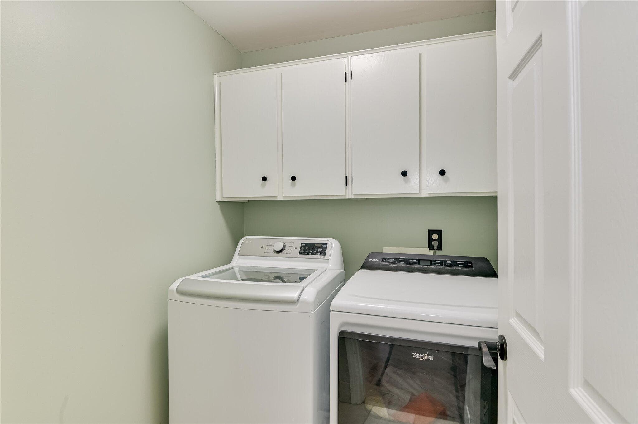 A convenient laundry room with built-in cabinetry for extra storage and an easy, practical setup for daily living. New washer and dryer convey with home. Still under warranty - 16 Rapids Court, North Augusta, SC 29841