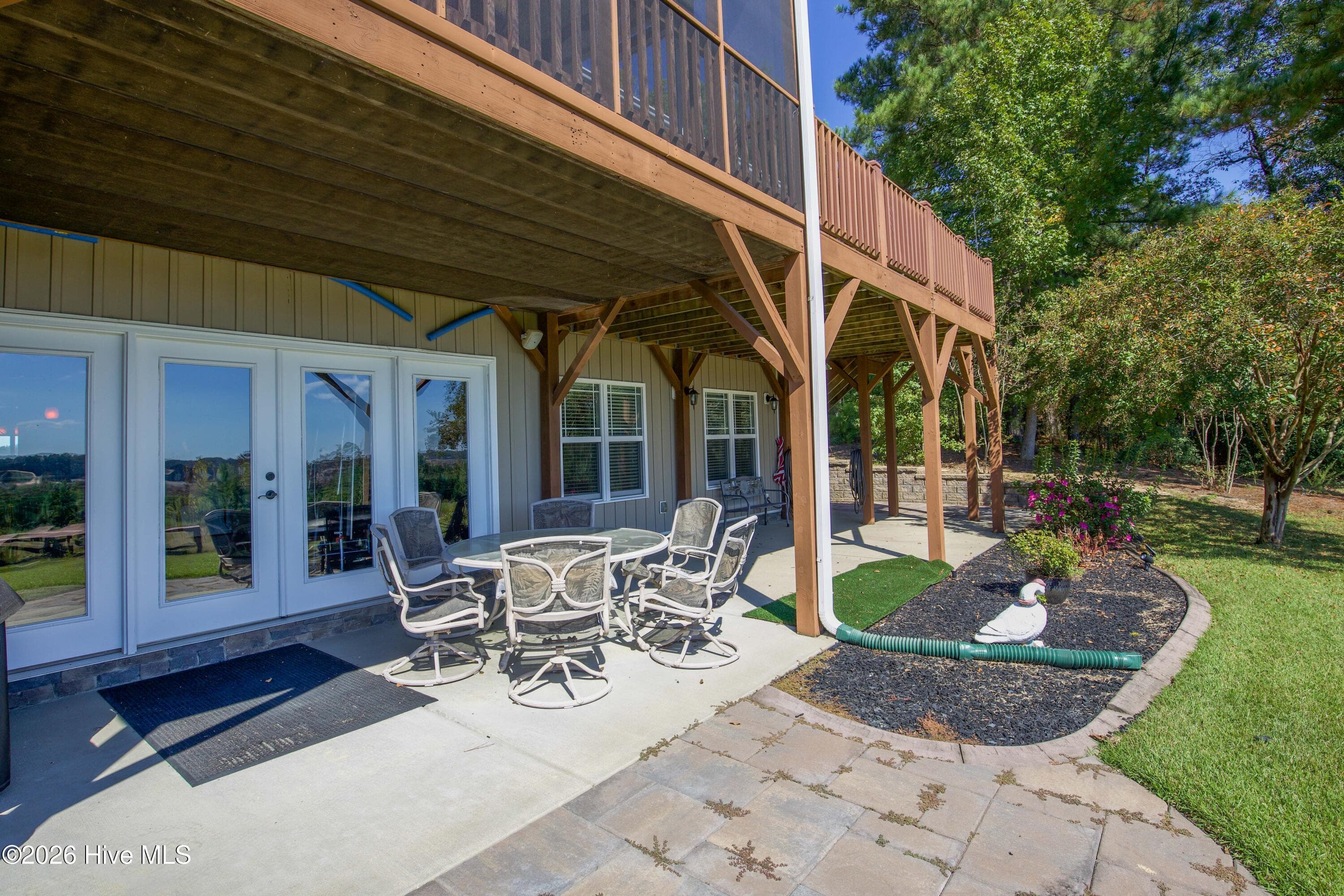 Finished walkout lower level opens to a covered patio beneath the deck at 899 Seagull Drive, Woodlake, Vass NC. - 899 Seagull Drive, Vass, NC 28394, Vass