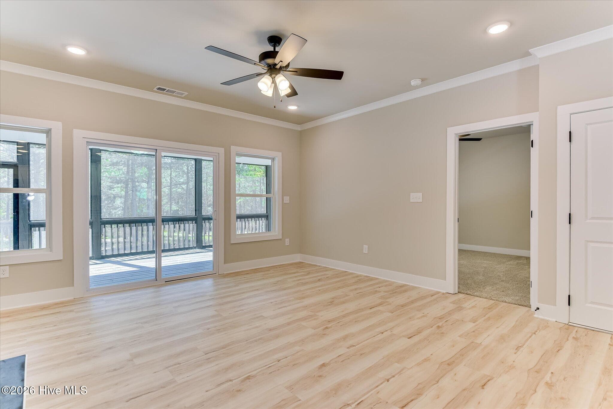 Sliding doors to rear screened porch, door to Primary bedroom - 1198 Sunset Cove, Tignall, GA 30668