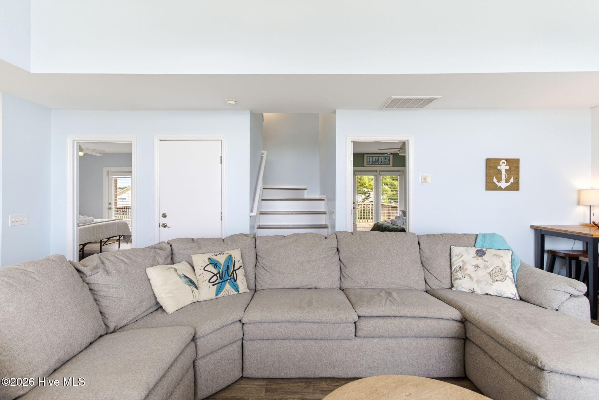 Living room and stairway - 2330 W Beach Drive, Oak Island, NC 28465