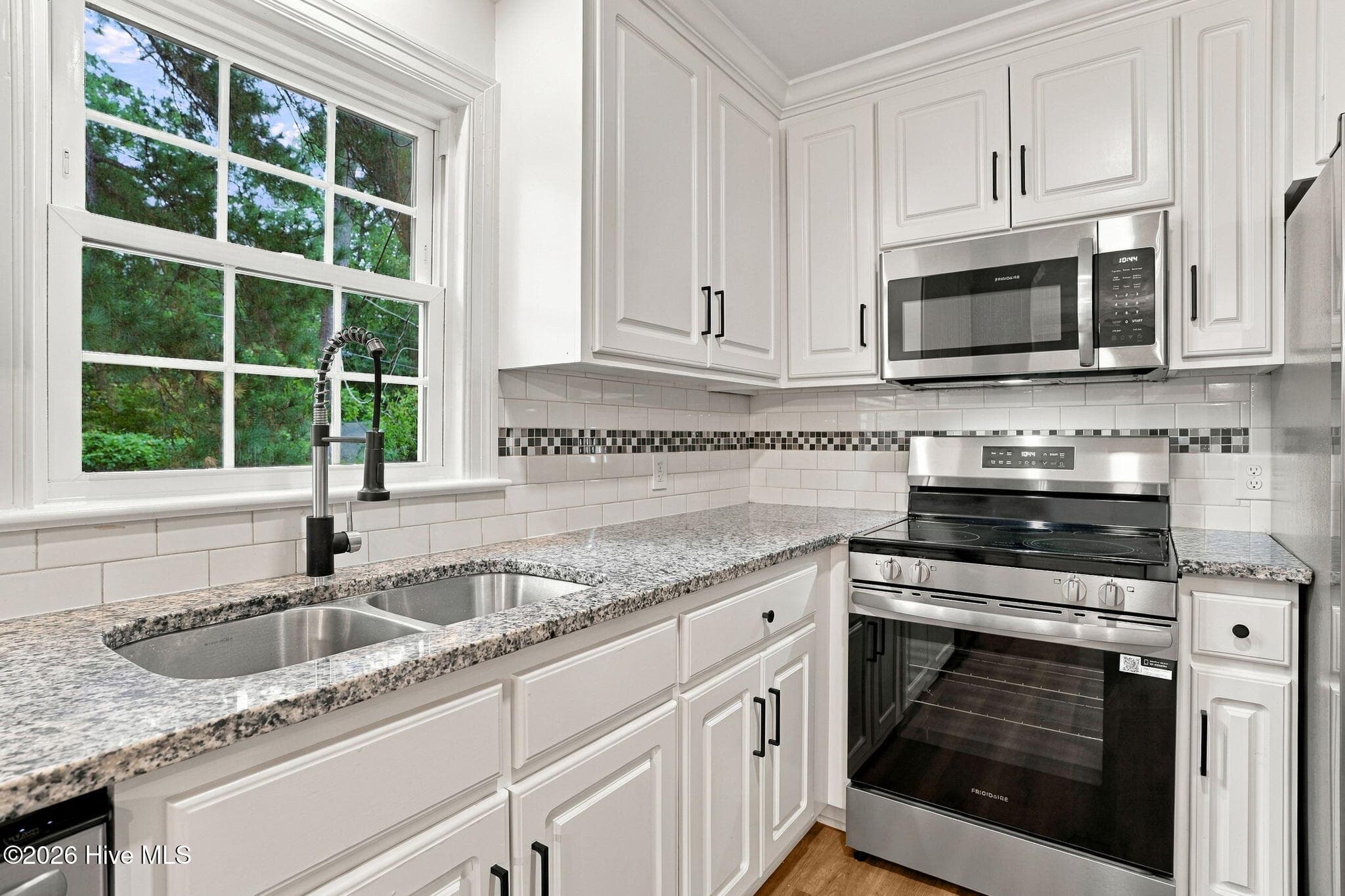 Updated kitchen with new flooring and cabinets - 2214 Somerset Drive N, Wilson, NC 27893