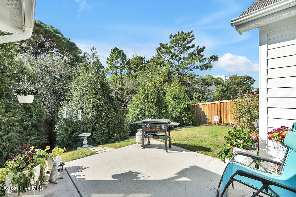 Take advantage of Wilmington’s greatest amenity, outdoor living, as you enjoy grilling, entertaining, or simply sunning on the extended patio. Relish the view from this prettily landscaped and irrigated lawn. If you hate to mow, this fenced backyard will be your favorite detail! - 142 Rice Marsh Way, Wilmington, NC 28412