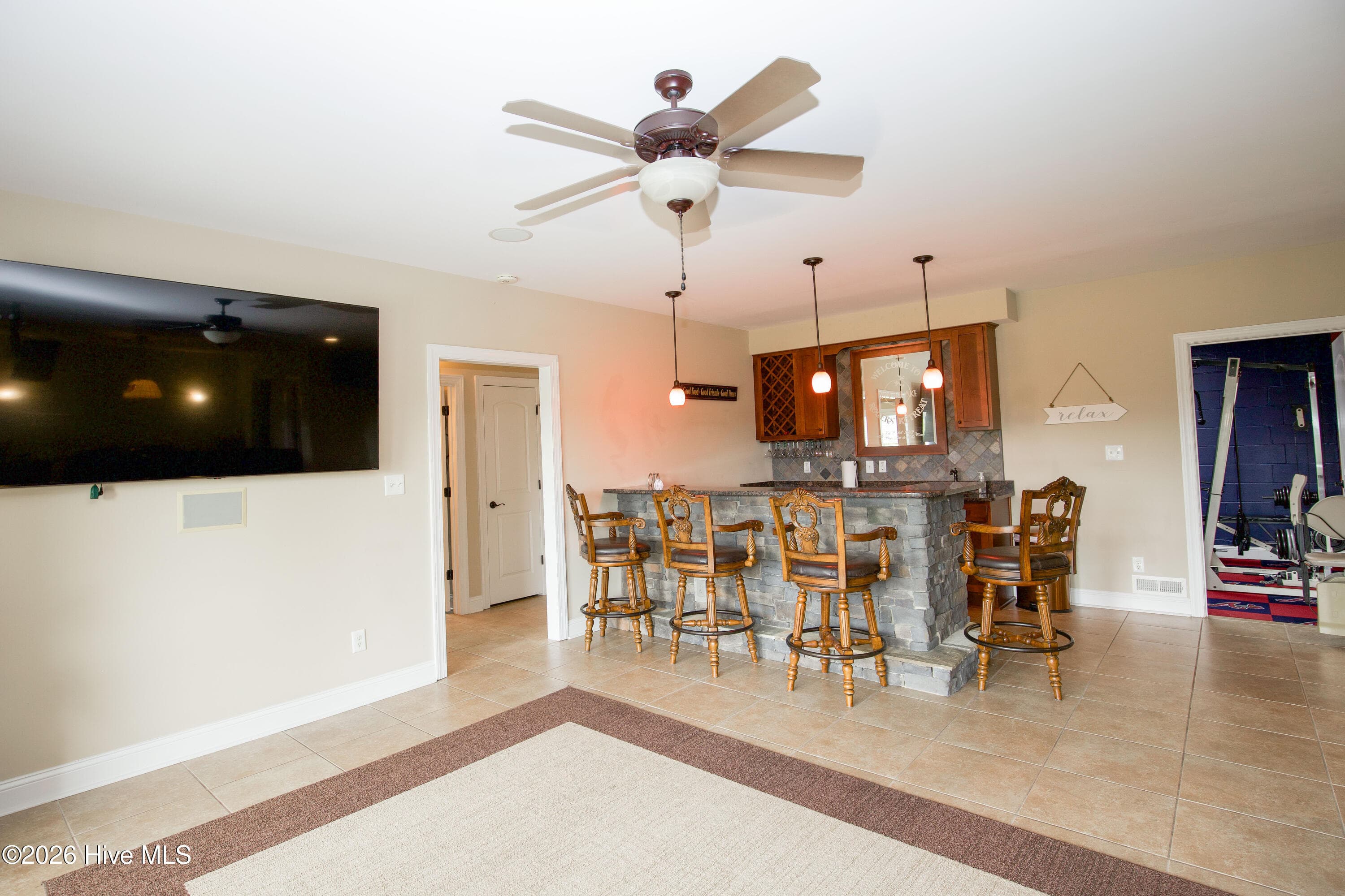 Media area looking toward the stone-front wet bar and exercise room. - 899 Seagull Drive, Vass, NC 28394, Vass