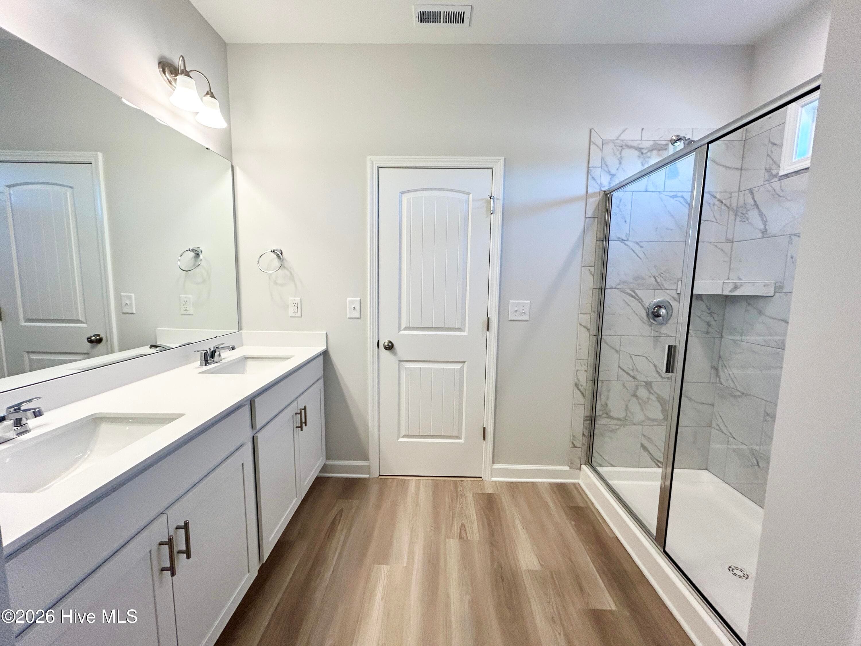 Primary Suite features a Private Bathroom with Tile Shower and Large Walk-in Closet - 4153 Workman Loop 68, Leland, NC 28451
