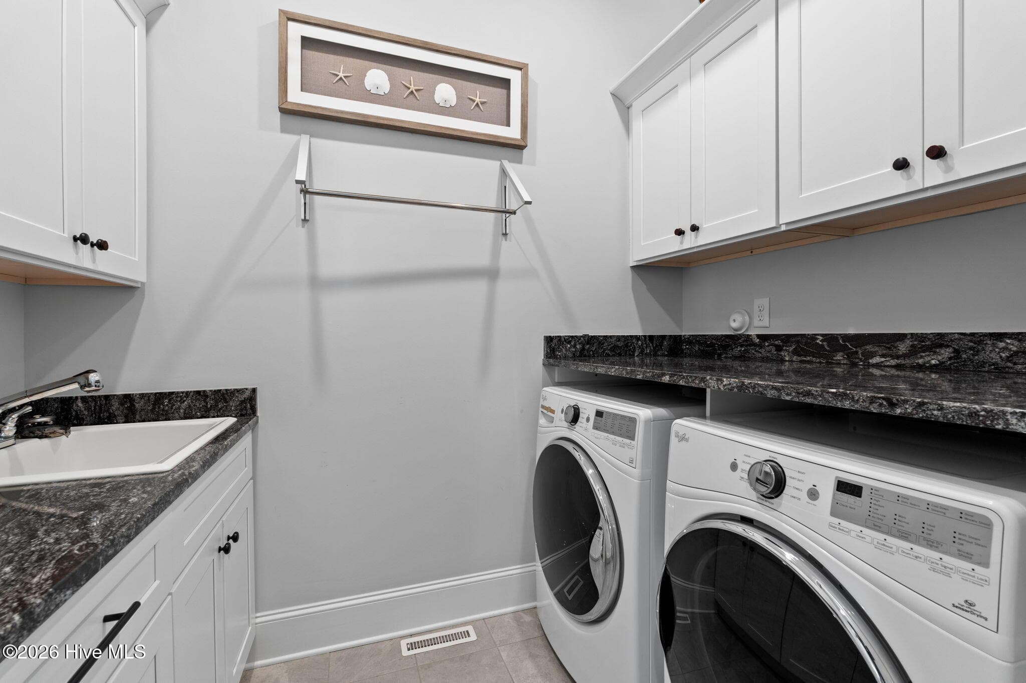 Front load washer and dryer included. Utility sink, lots of storage and a drying rack complete this room - 2775 Long Bay Drive SE, Southport, NC 28461