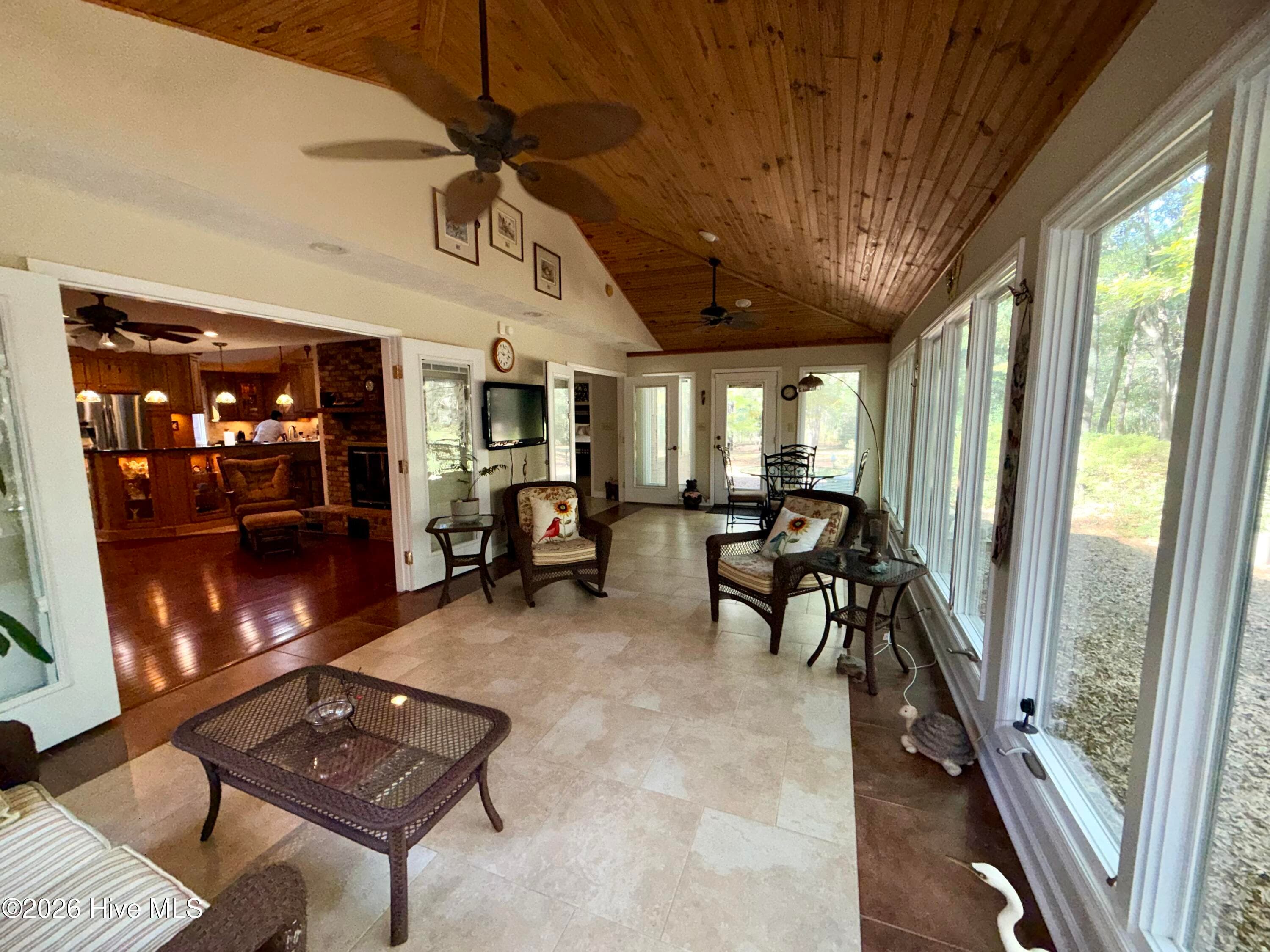 large sunroom surrounded by nature - 12681 Blues Farm Road, Laurinburg, NC 28352